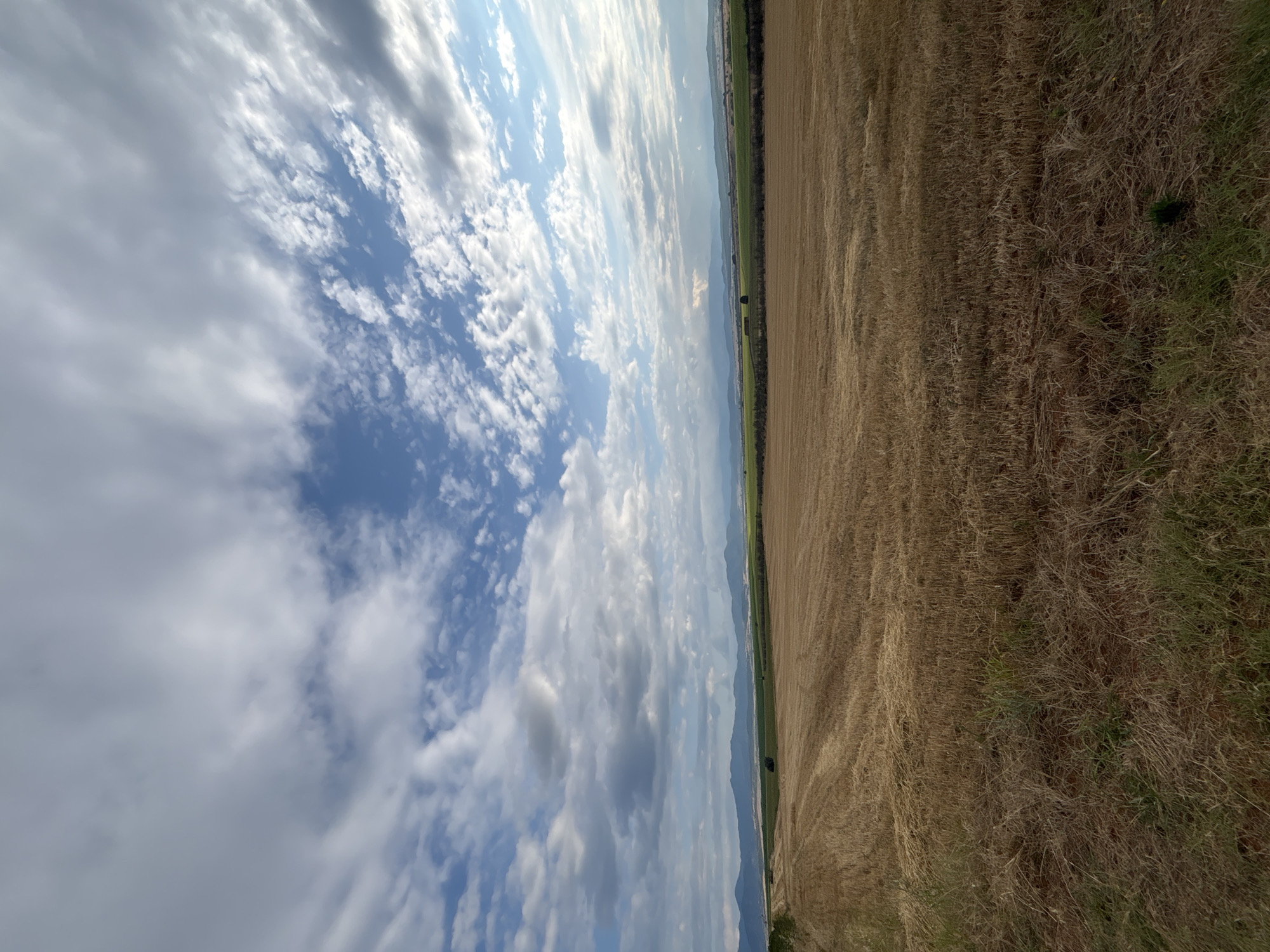 Post-harvest fields and parked tractor near Hisarya, Bulgaria