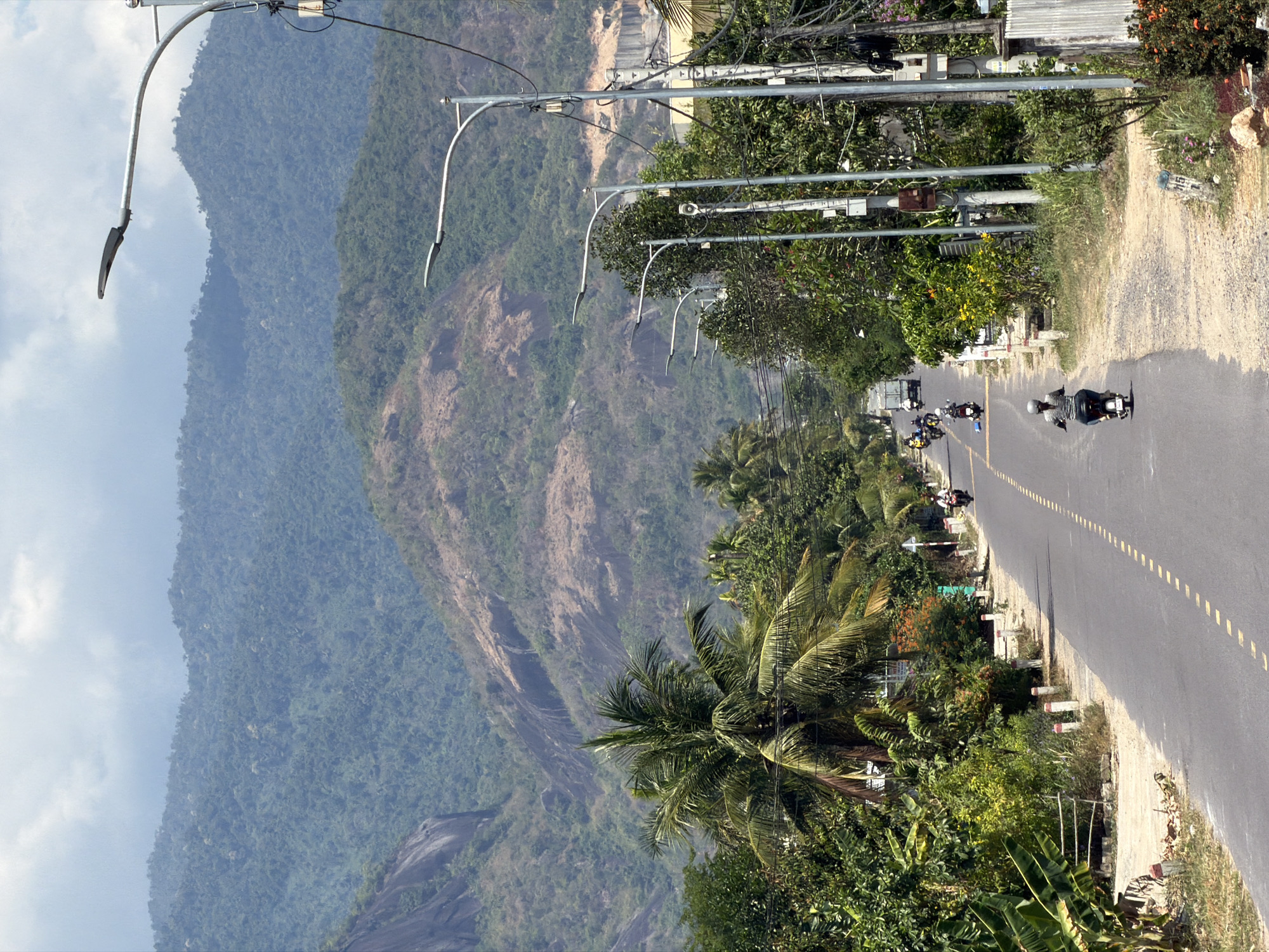 Morning traffic flows on mountain road in Diên Thọ, Vietnam