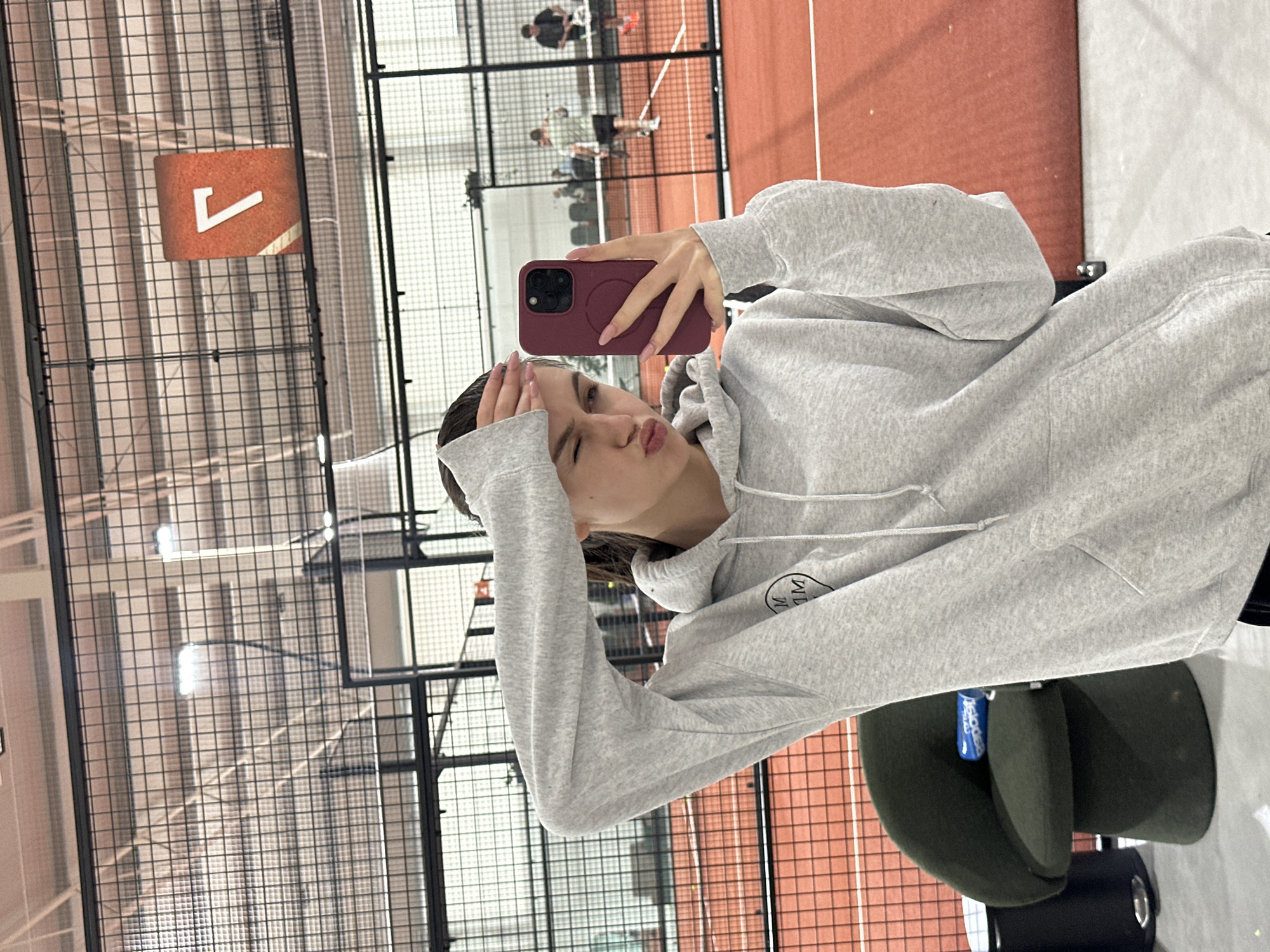 Woman documents morning visit to indoor padel tennis facility