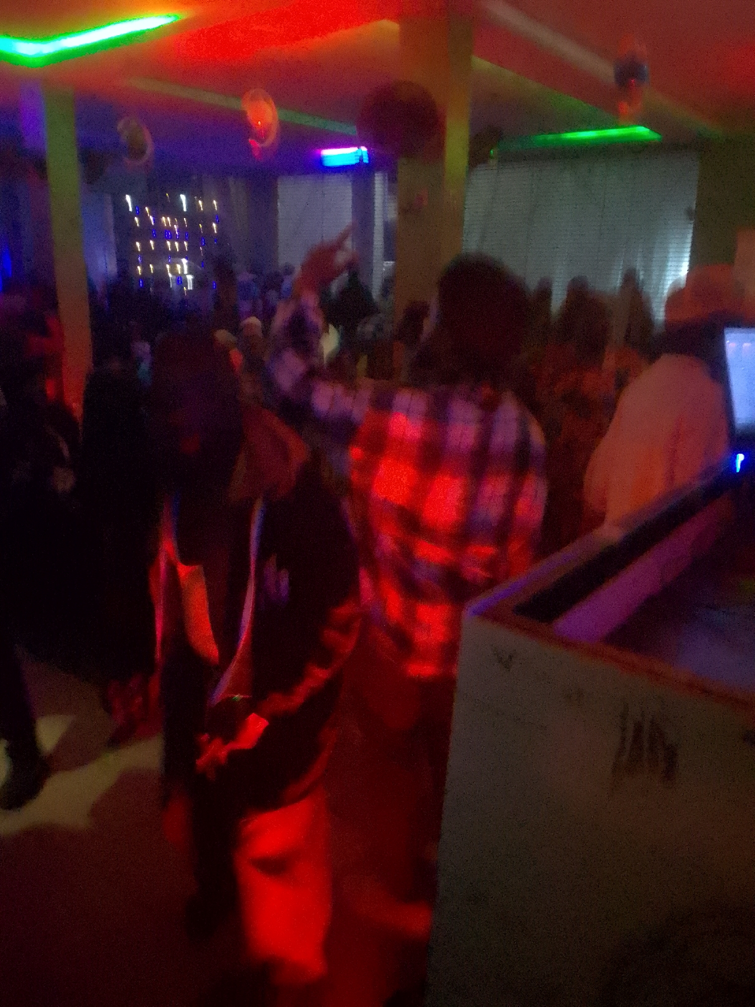 Nighttime bar gathering documented through dimly lit venue scenes