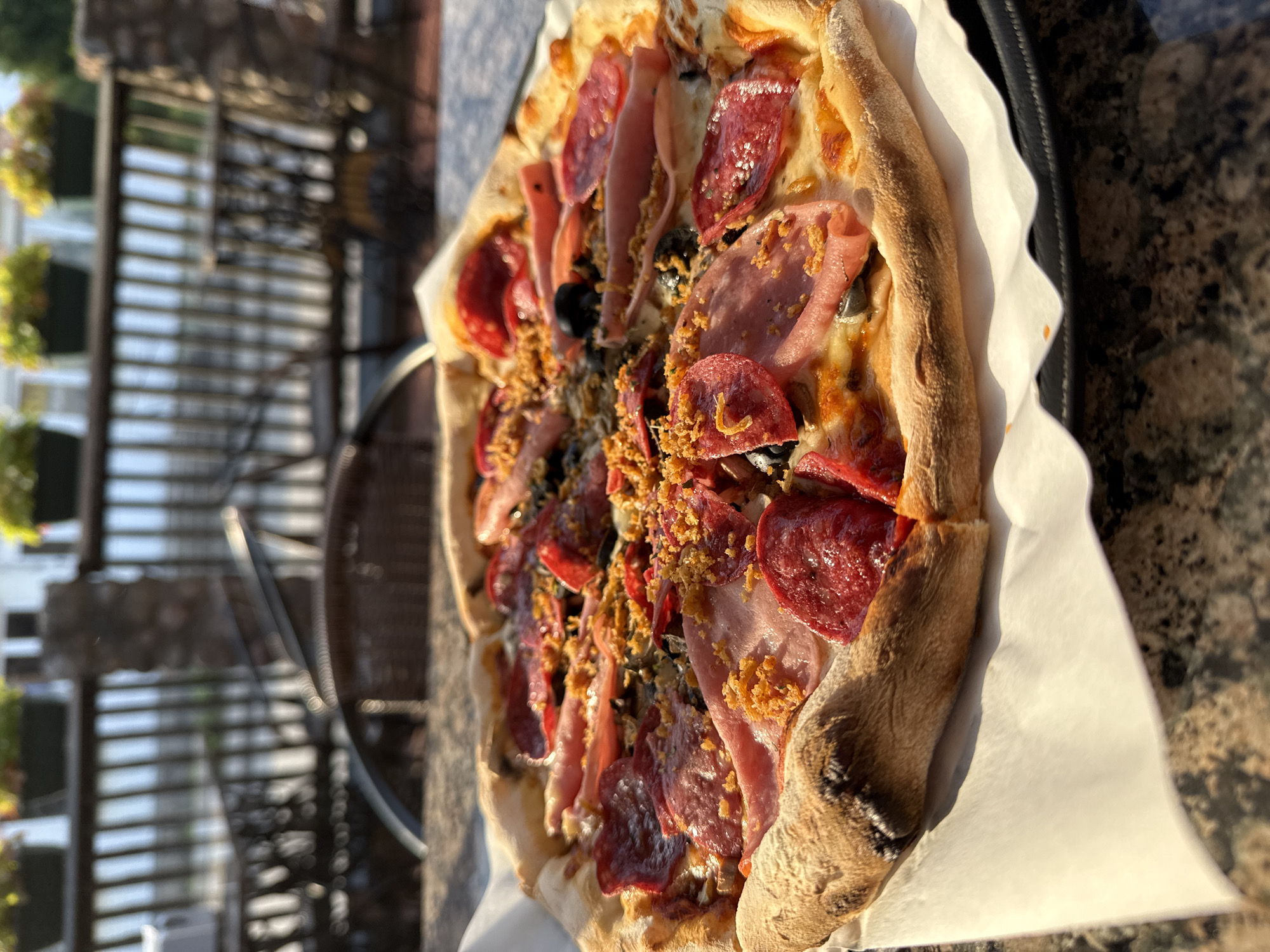 Outdoor pizza lunch in Rūdiškės under a dramatic summer sky