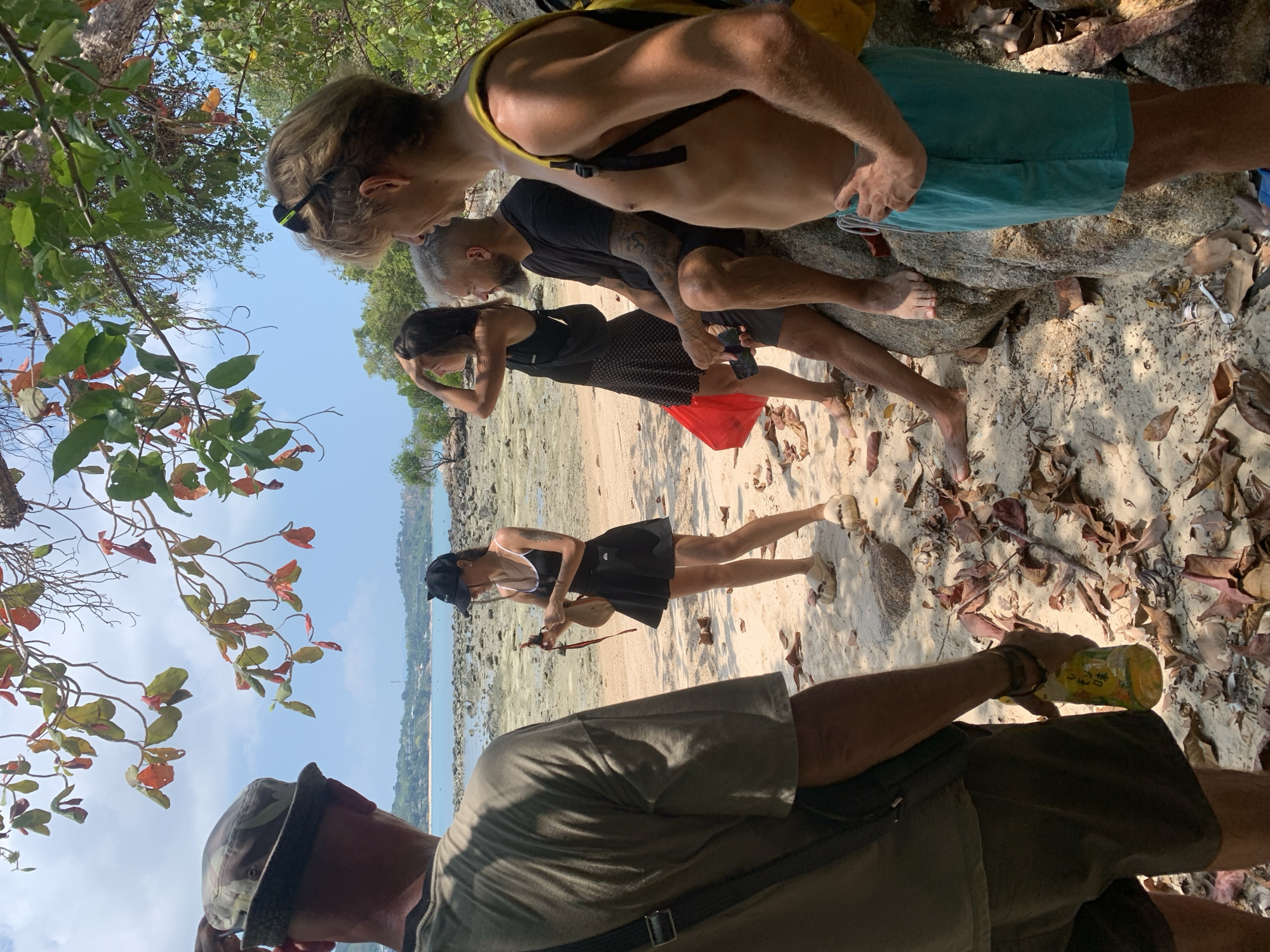 Five people gather on sunny Ko Samui beach