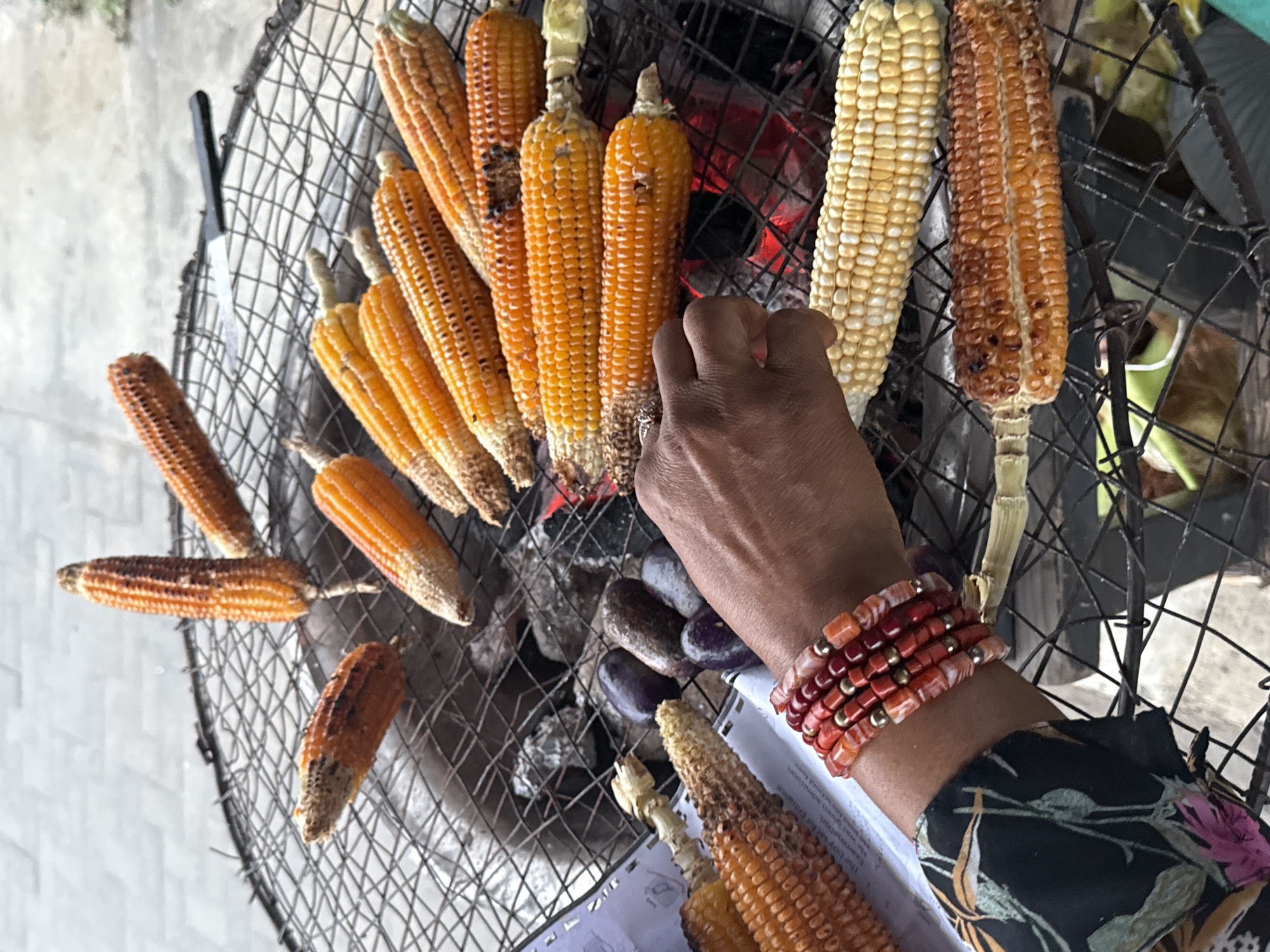 Corn grilling at a street food spot in Ado, Nigeria
