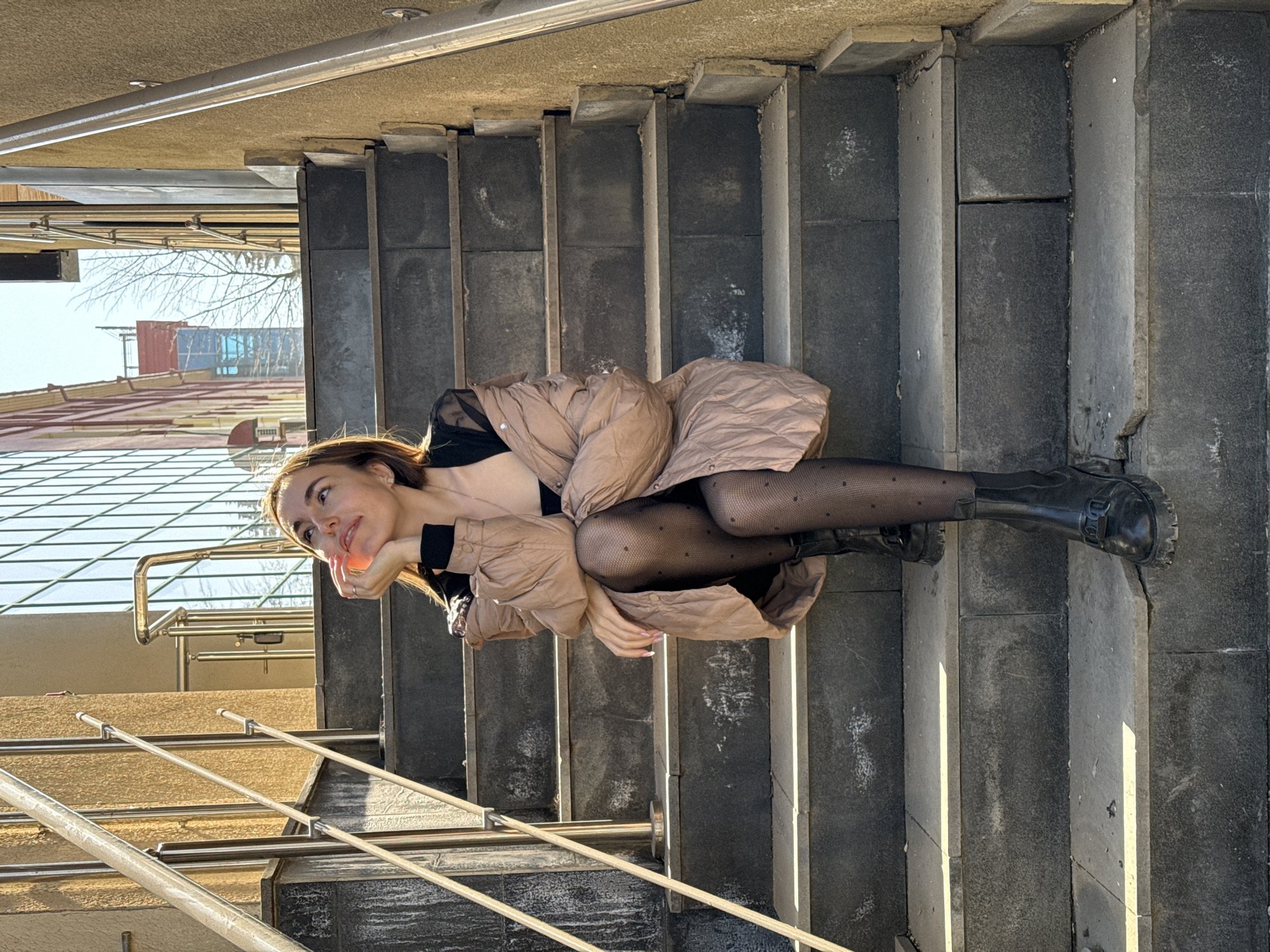 Woman poses with musician statues in Izhevsk public arts area