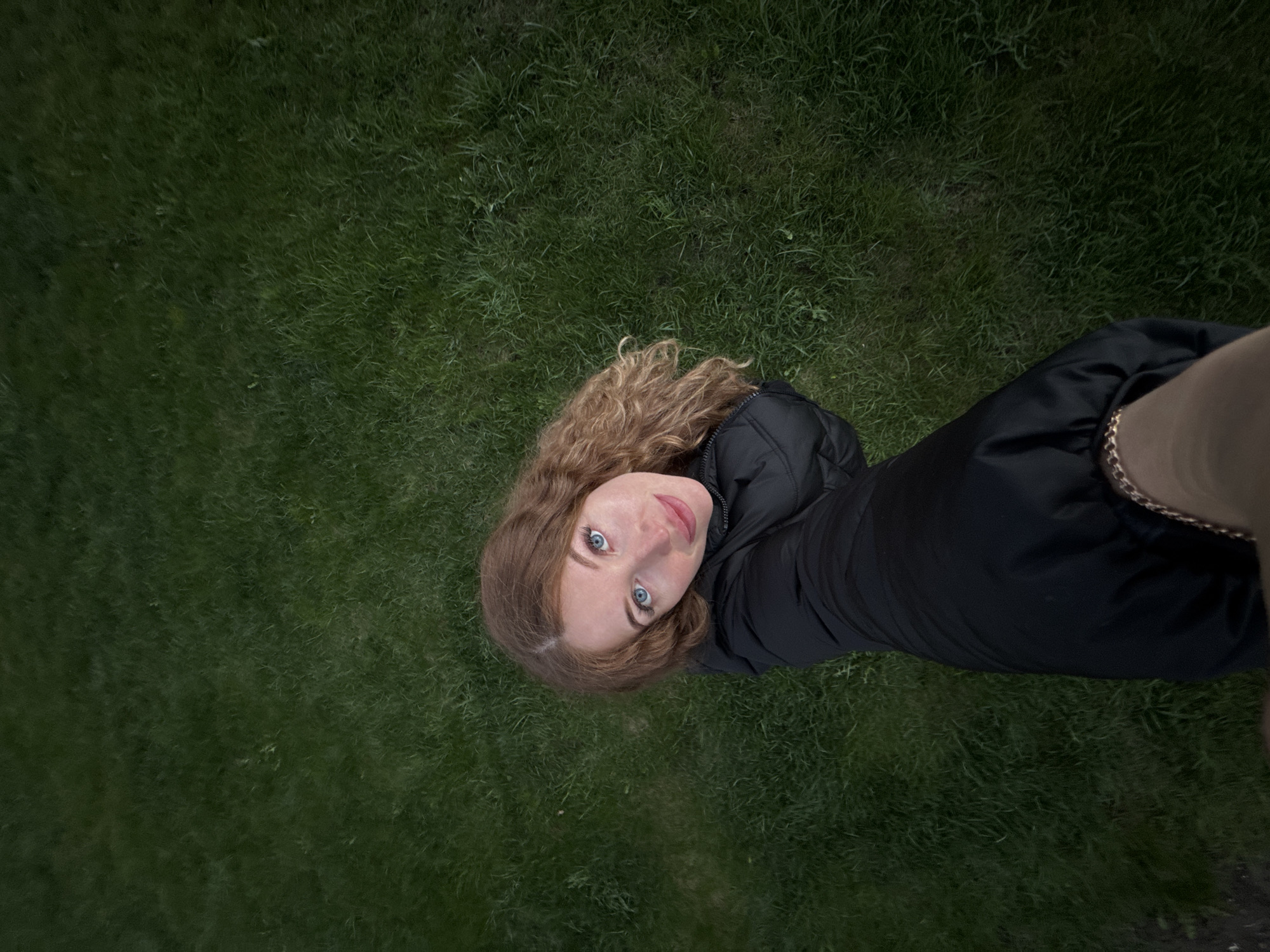 Woman photographs herself among spring daffodils in Russian garden