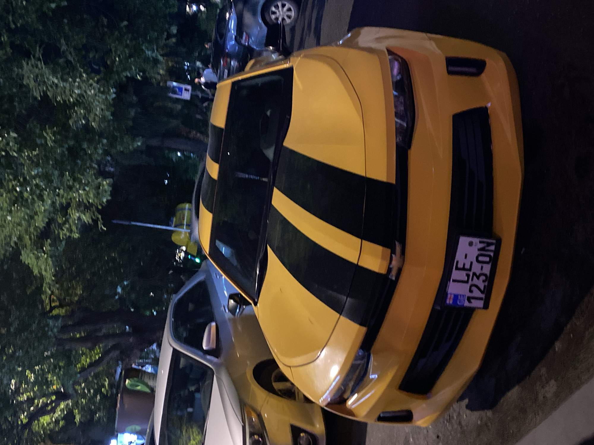 Bumblebee-styled Camaro parked on a Batumi street at night