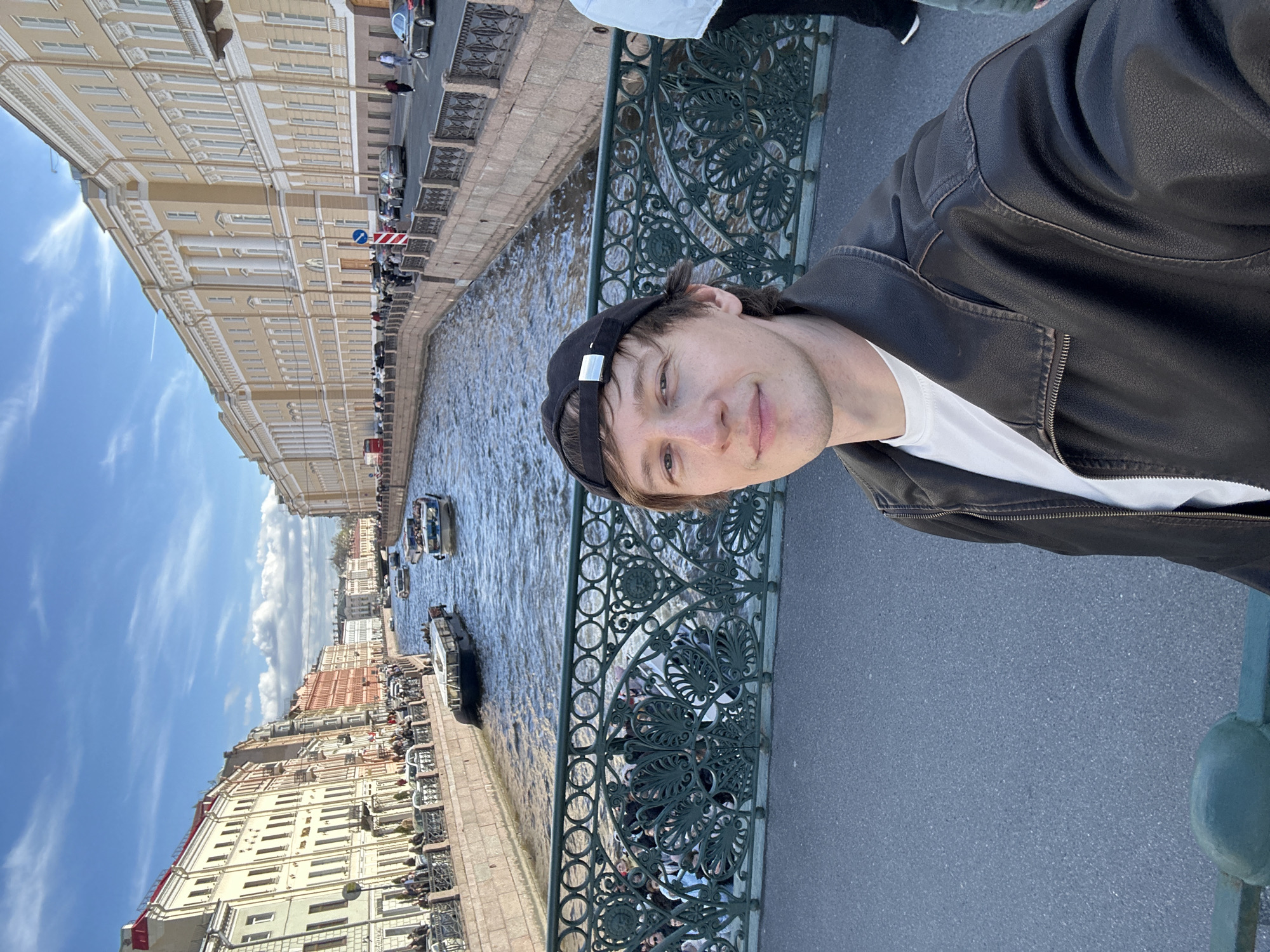 Tourists gather at Saint Petersburg canals during sunny afternoon