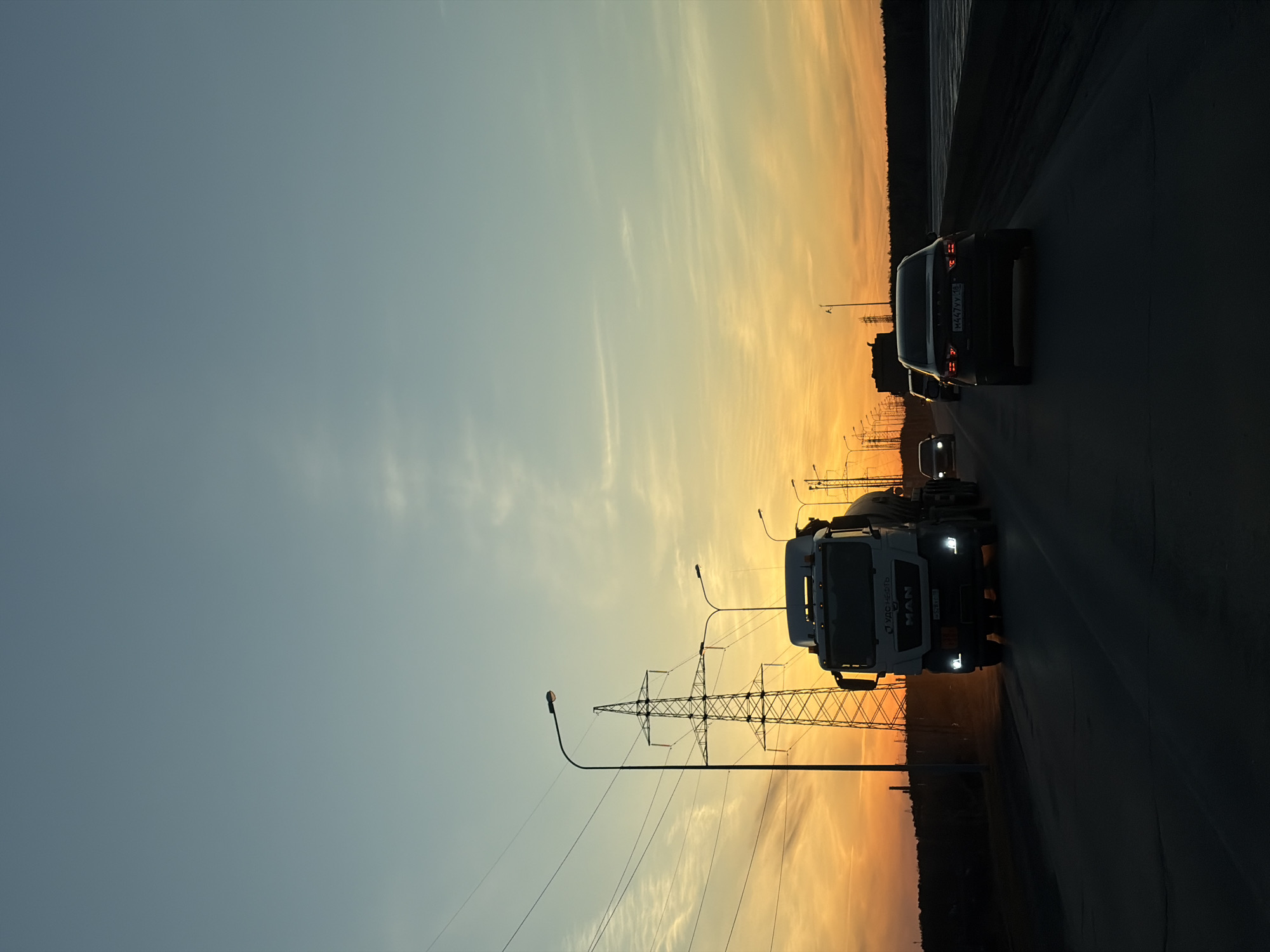 Evening traffic flows through Chaikovsky as daylight fades