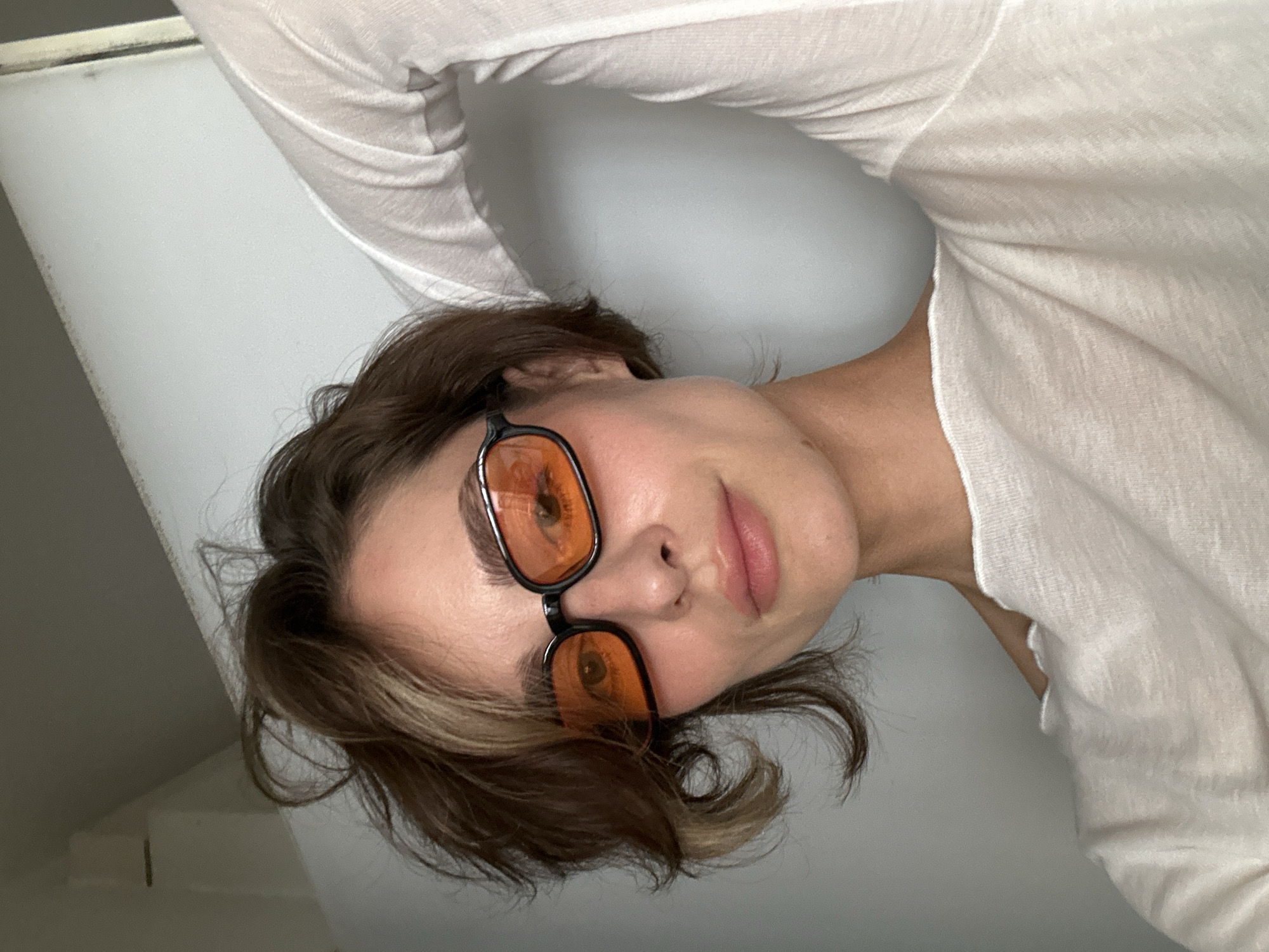 Woman takes selfie session in orange glasses, Kiel