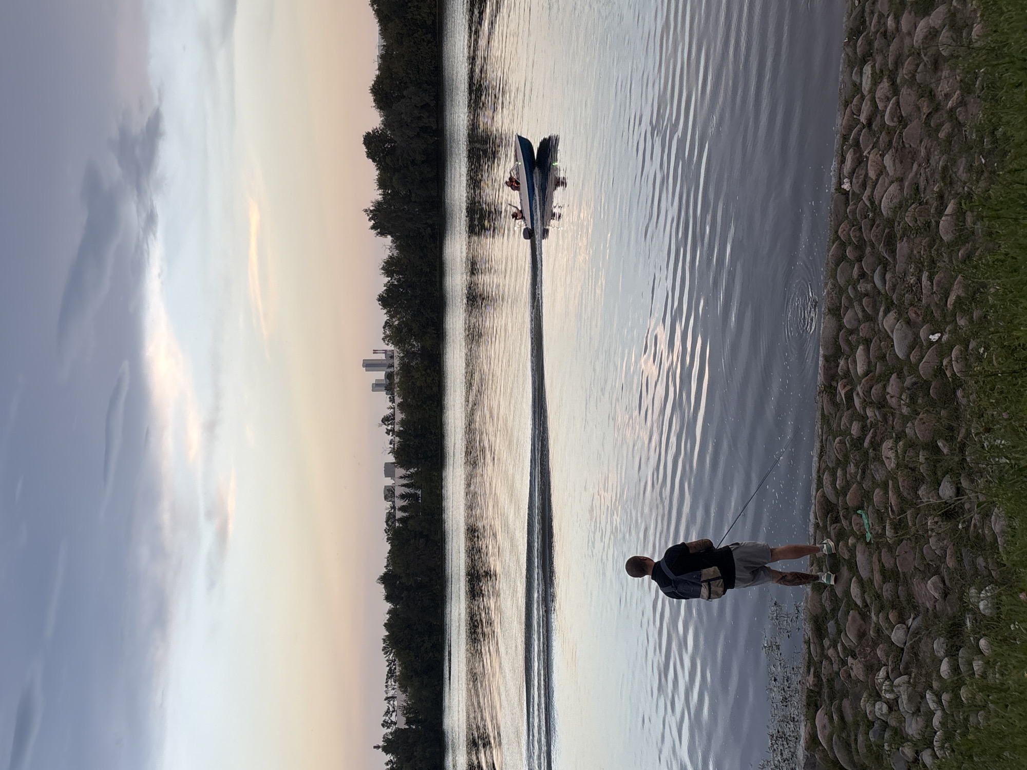 Moscow riverbank at dusk, fishing and leisure on a summer evening