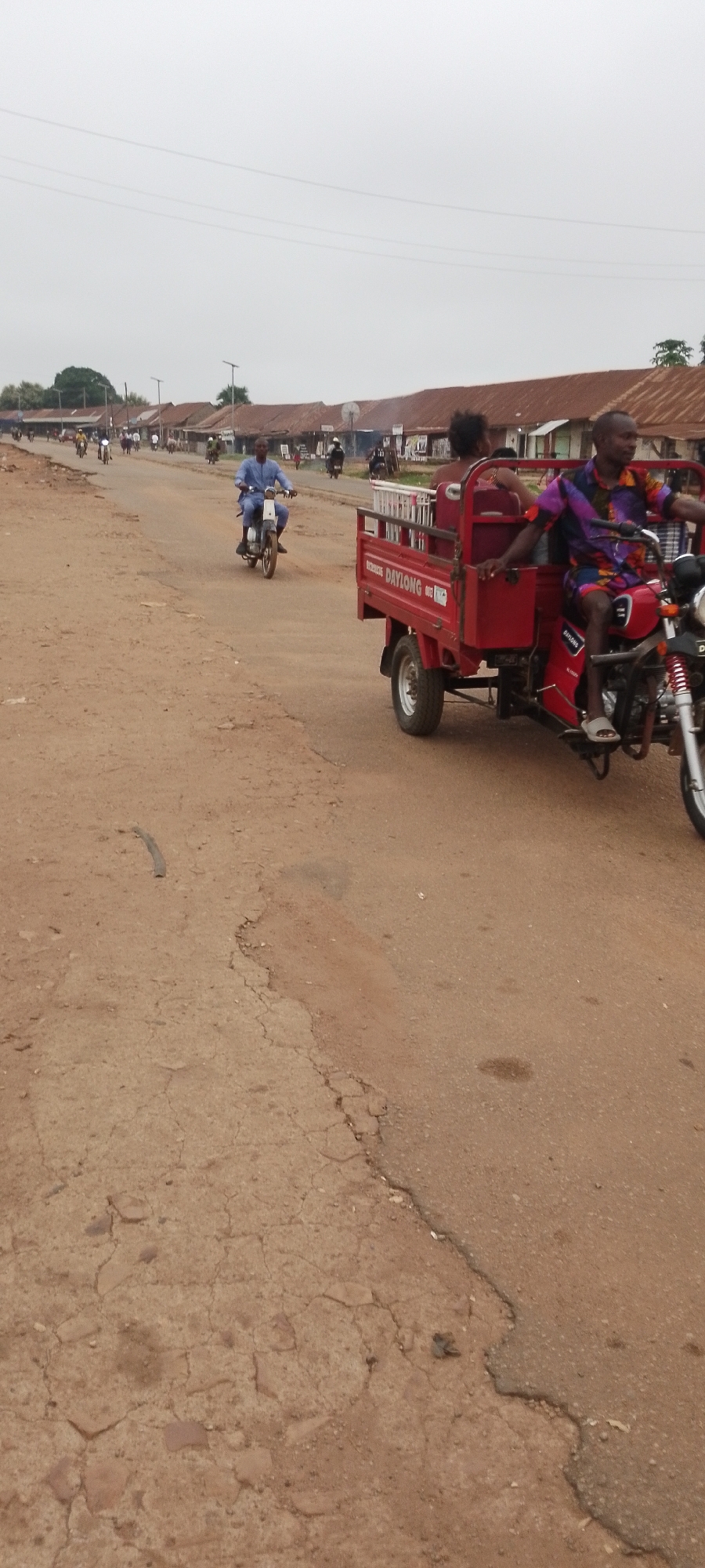 Morning street life along a dusty African town road
