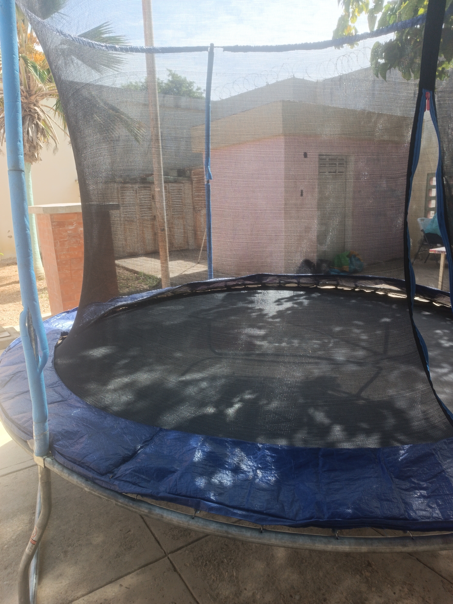 Children play on backyard trampoline in Porlamar, Venezuela