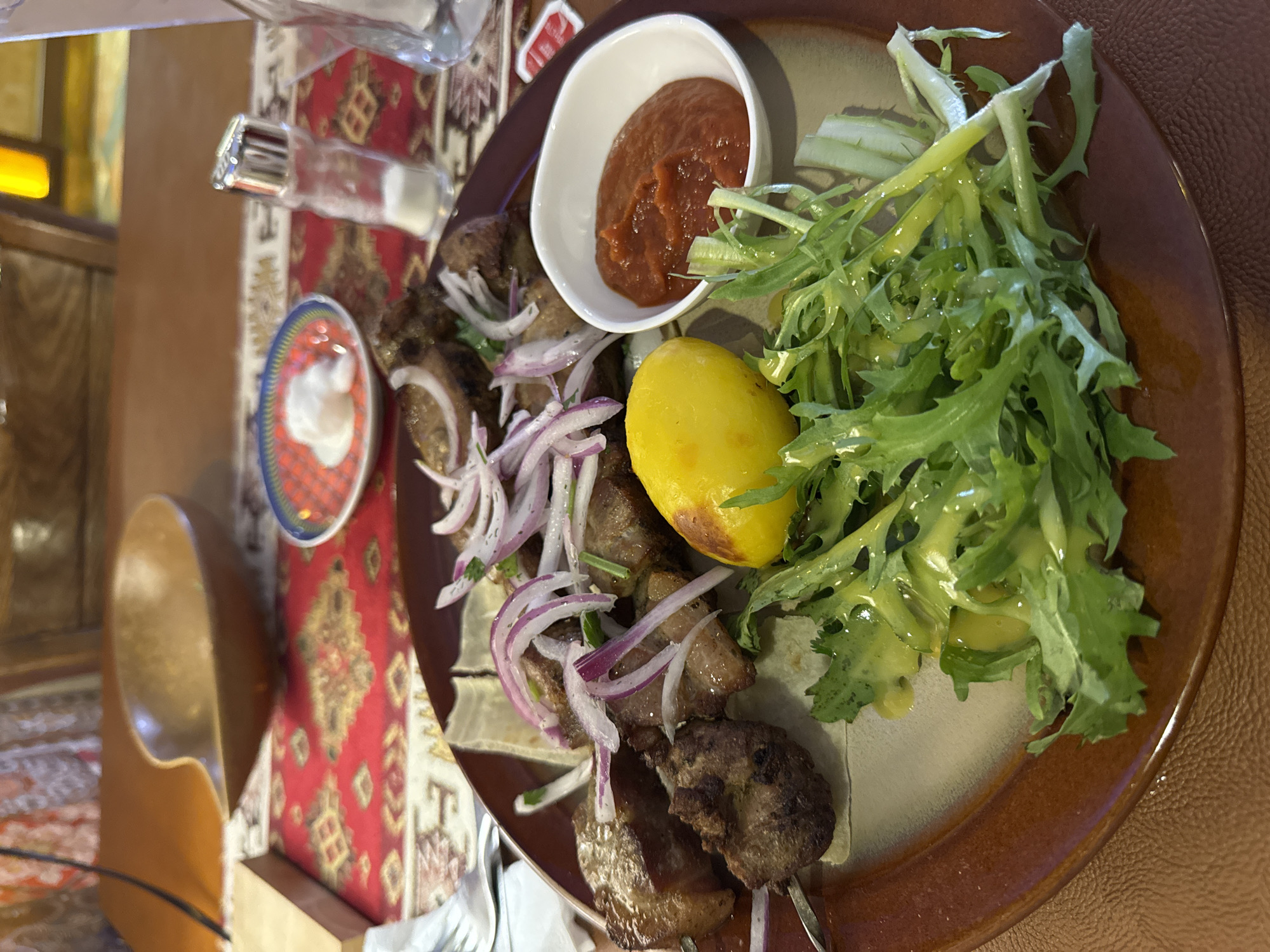 Restaurant meal documented in Ulaanbaatar featuring grilled meat skewers