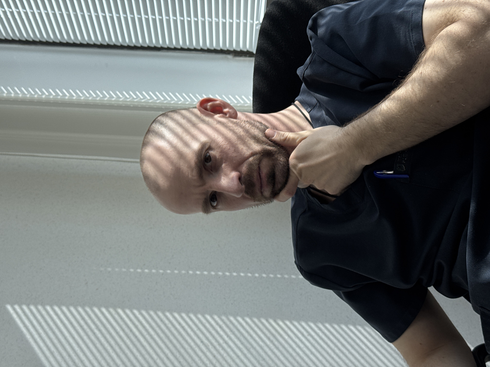 Man poses for casual portraits near window in Russia