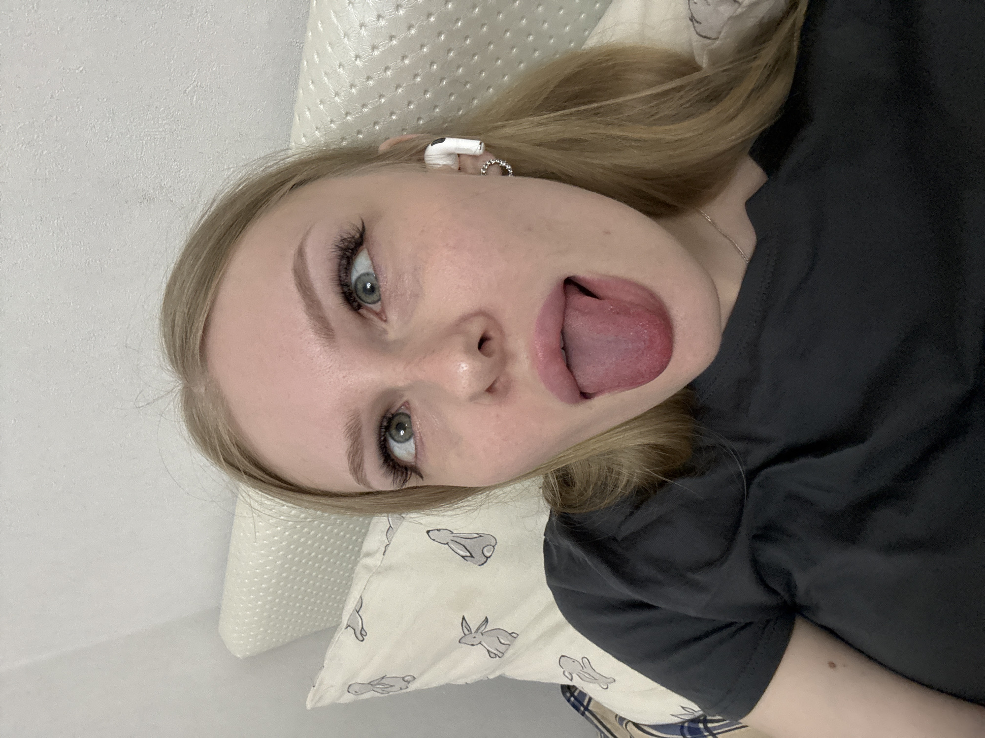 Relaxing at home in Perm, earbuds in, taking it easy