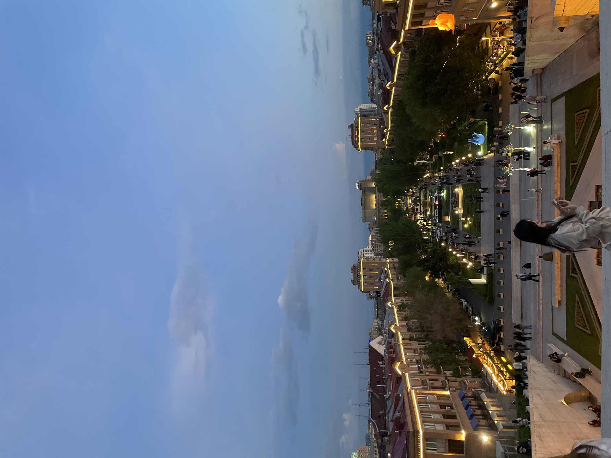 Evening strollers gather at illuminated Yerevan Cascade at dusk