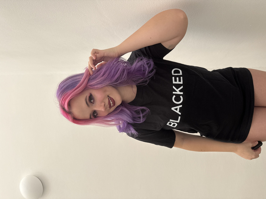 Woman with pink-purple hair photographs self in Zagreb residence