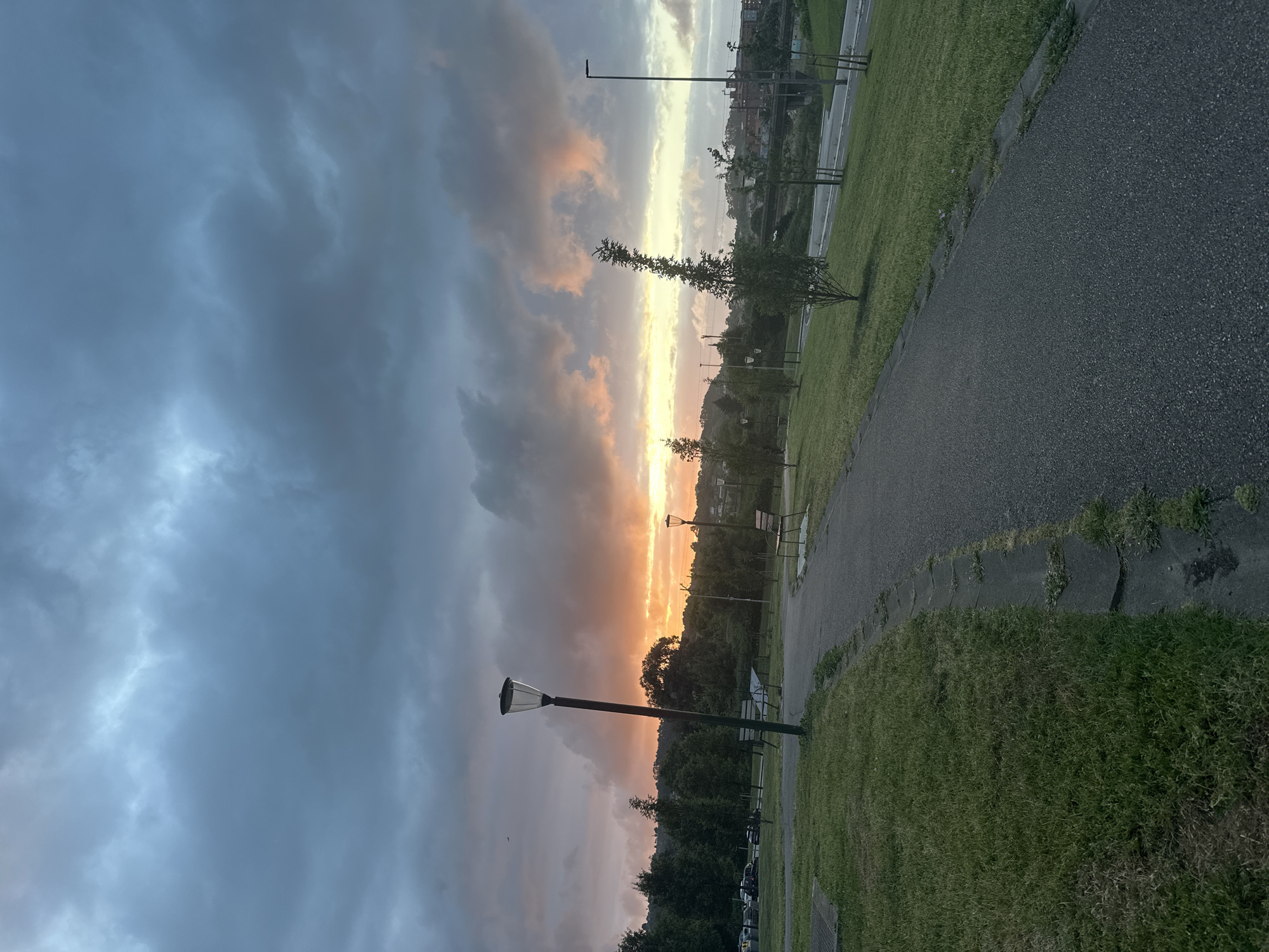 Dramatic sunset photographed over Gijón park during golden hour