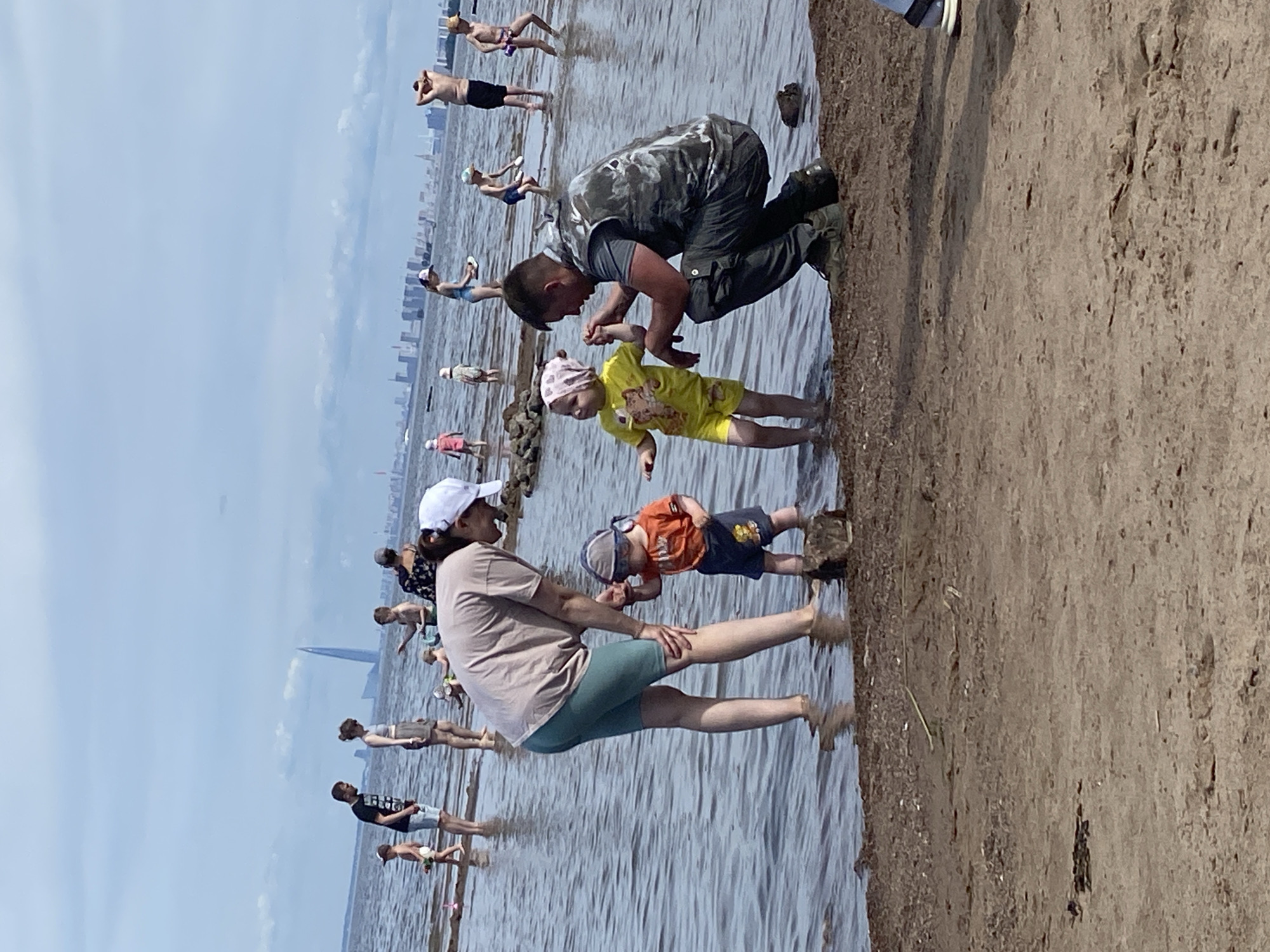 Kids playing in Gulf of Finland shallows, Saint Petersburg summer morning