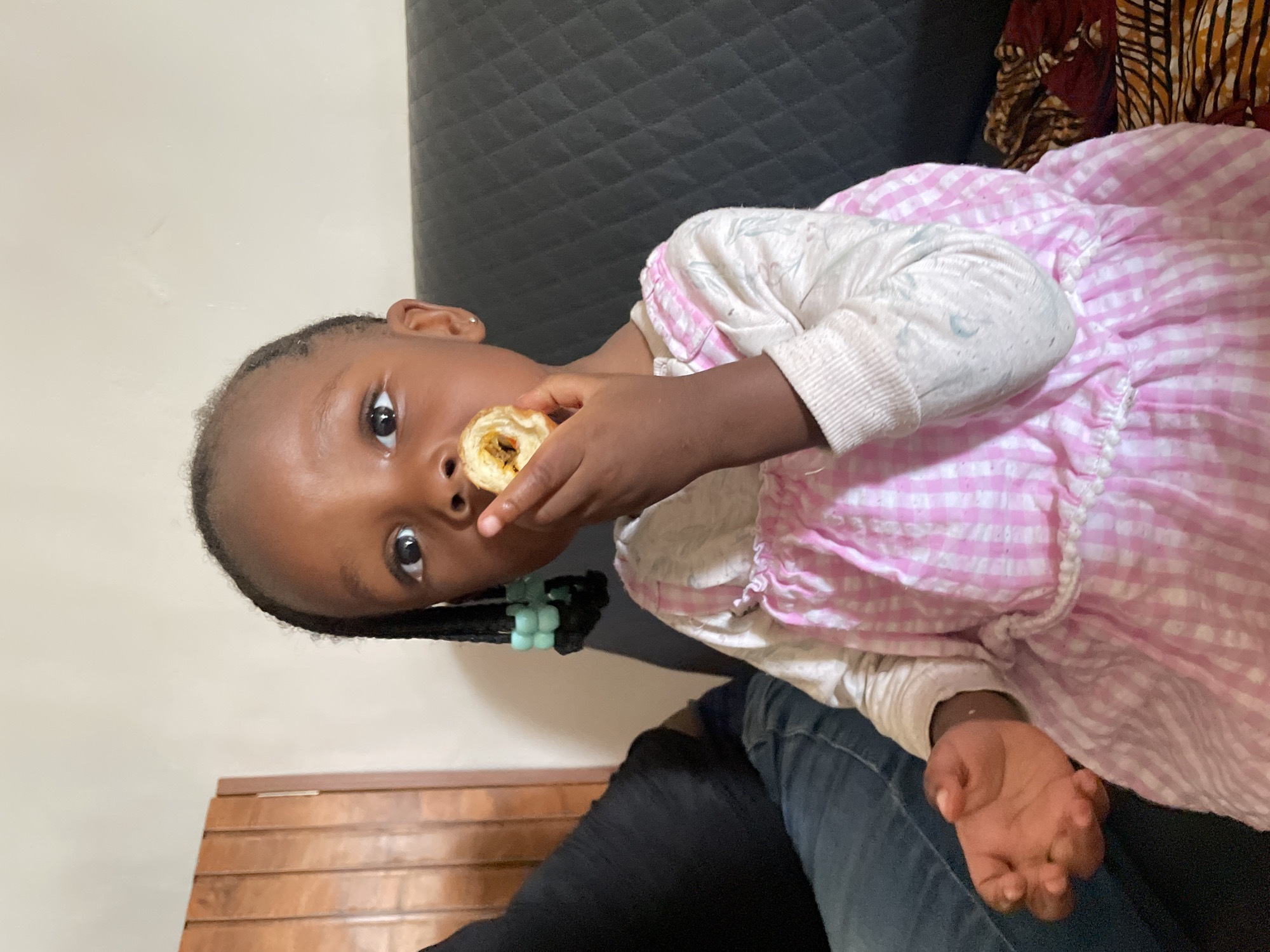 Young girl photographed with family member in Nigeria home