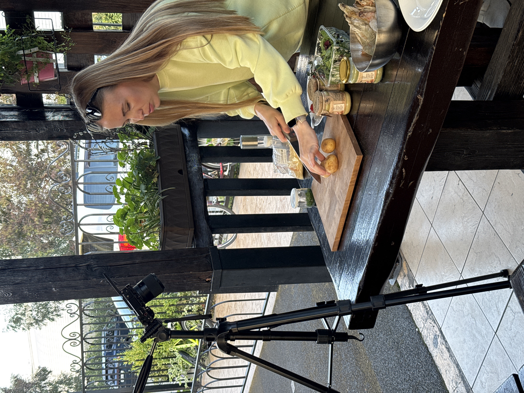 Woman grills seafood outdoors in Sirius, Russia