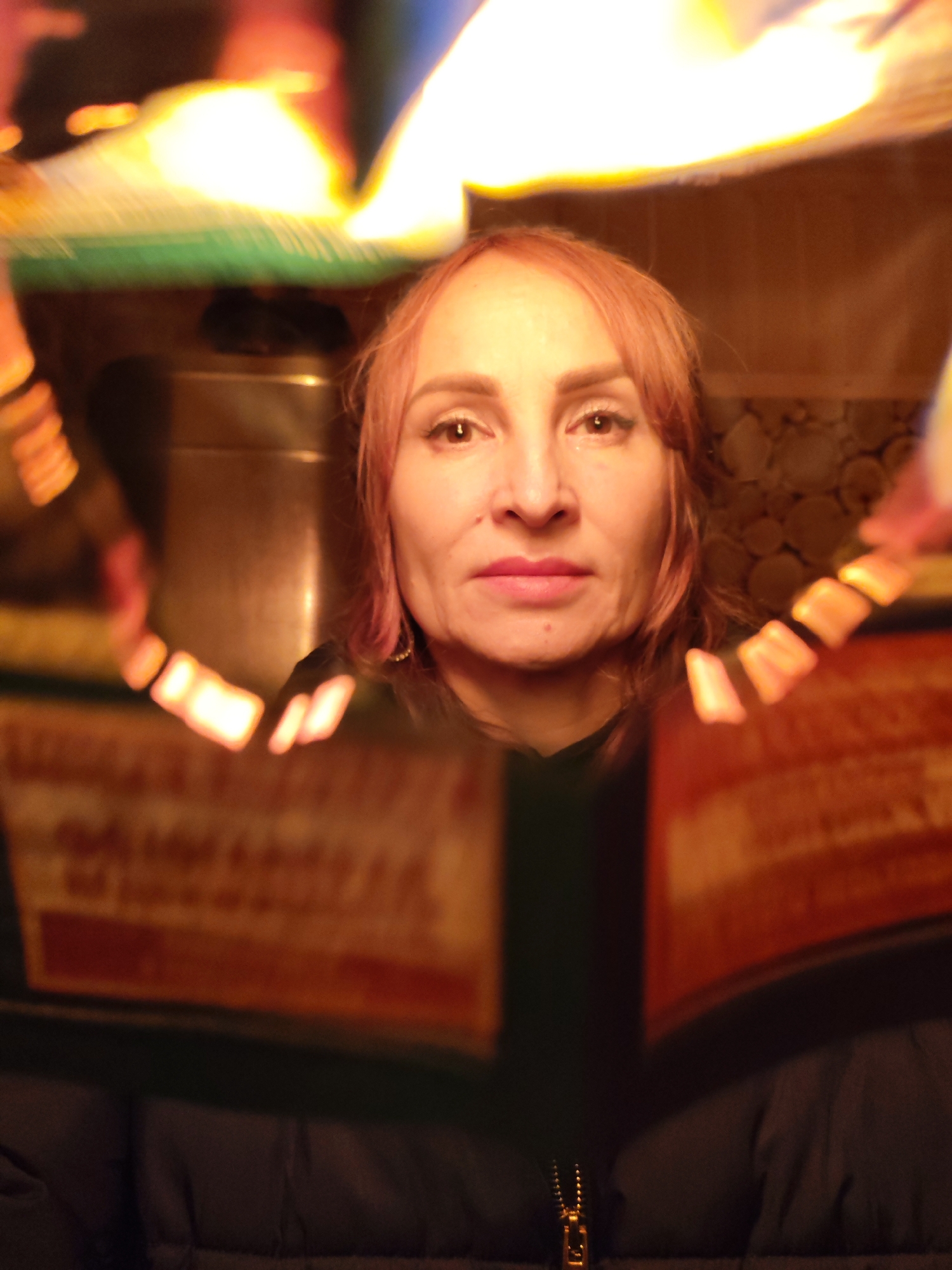 Woman photographed with burning newspaper containing Cyrillic text