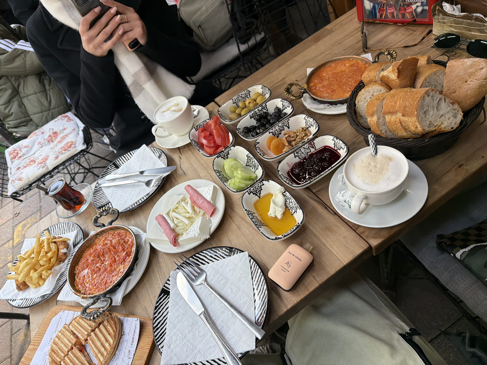 Couple enjoys traditional Turkish breakfast at Istanbul outdoor cafe
