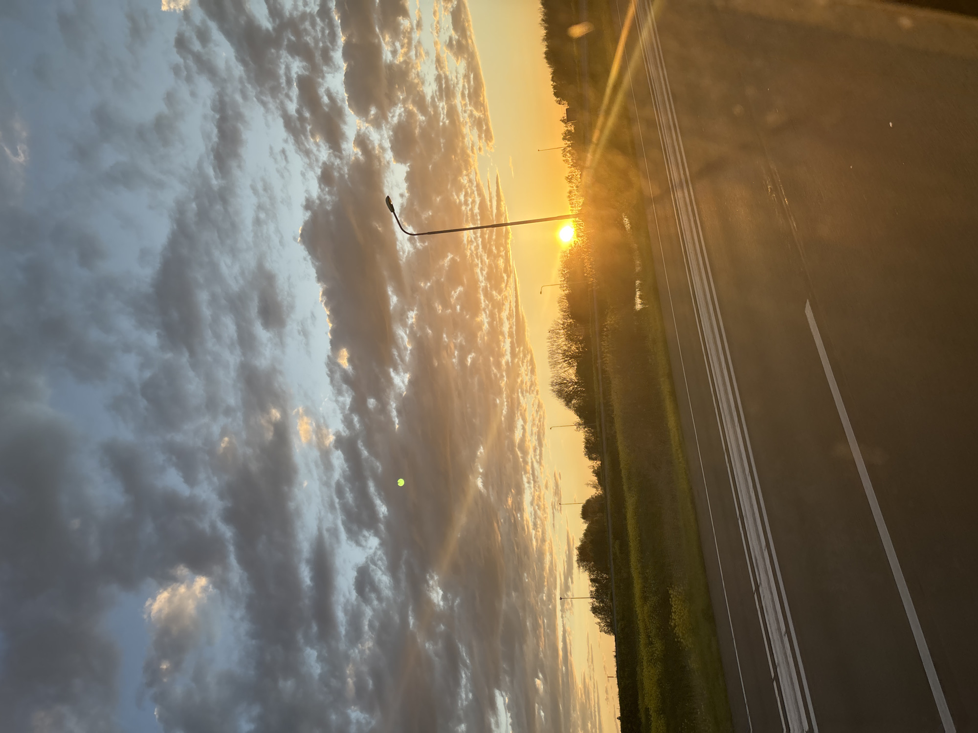 Highway sunset creates orange glow over Culemborg landscape