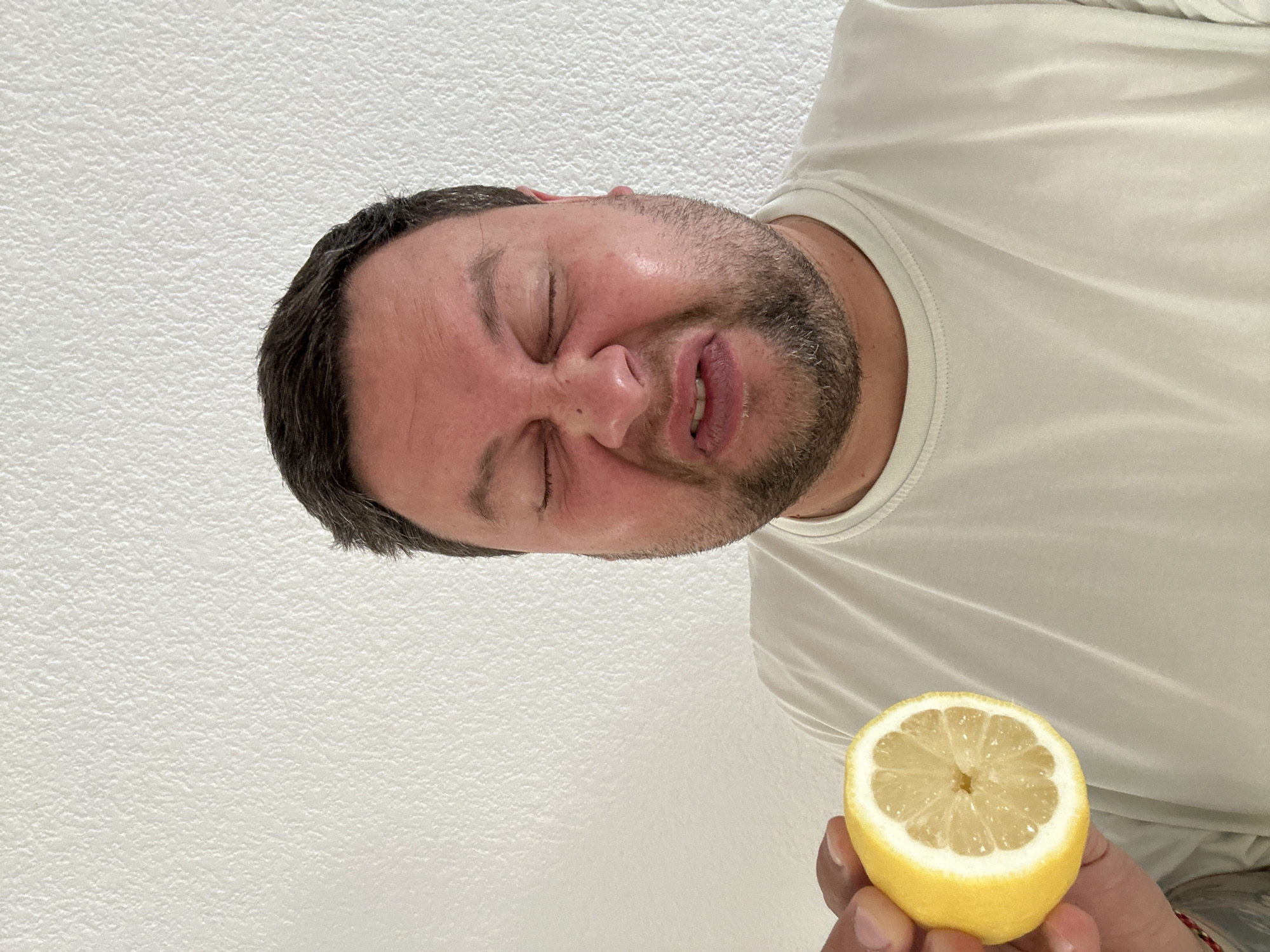 Man tastes lemon in Spanish coastal town fruit display