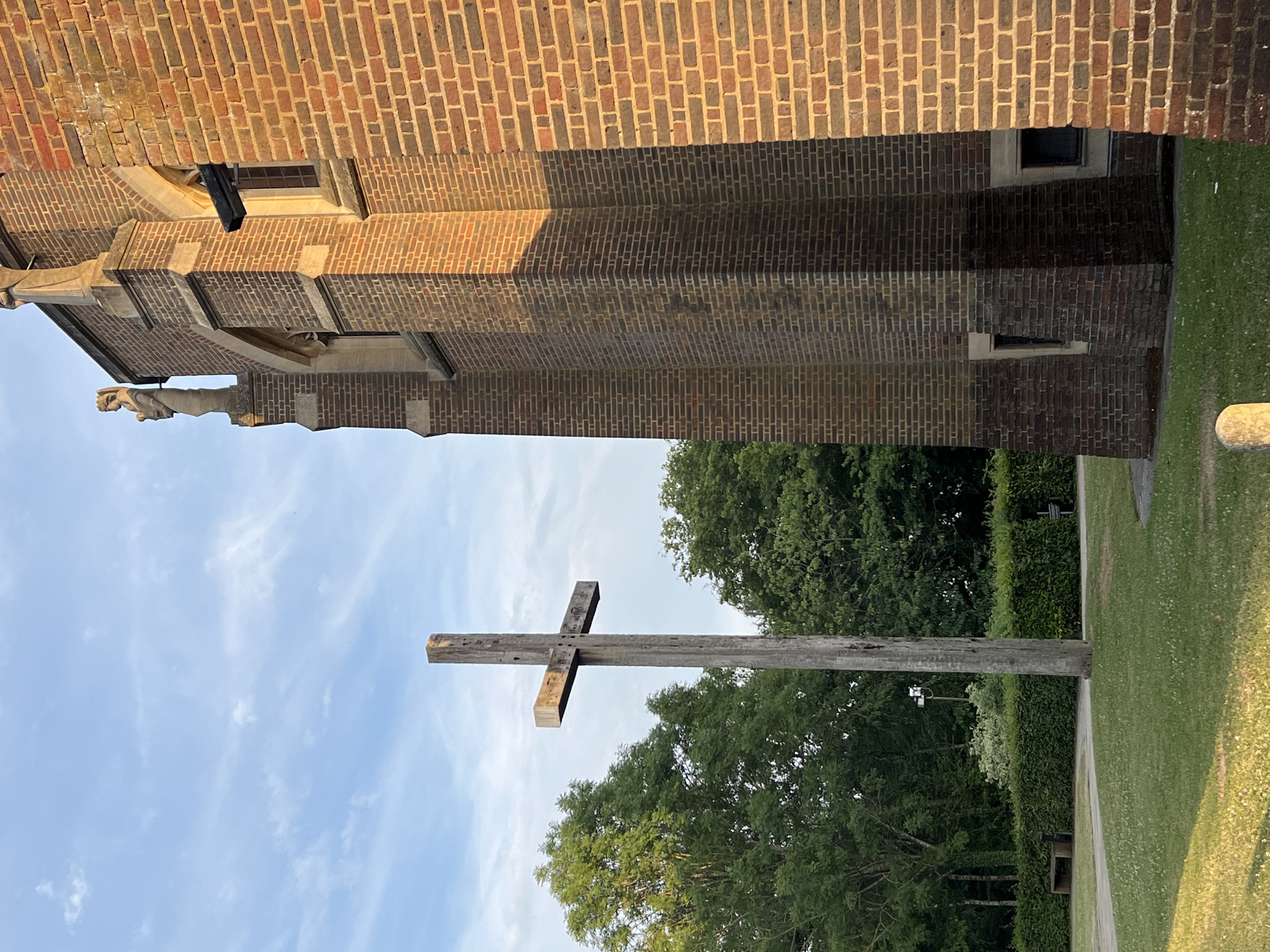 Wooden cross outside a brick building in Guildford