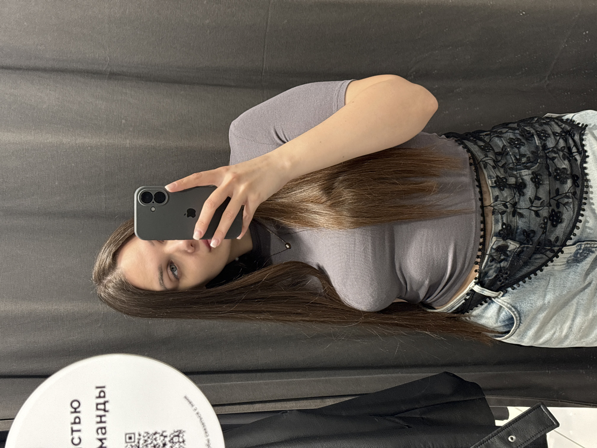 Person tries on clothes, takes mirror selfies in Yekaterinburg dressing room