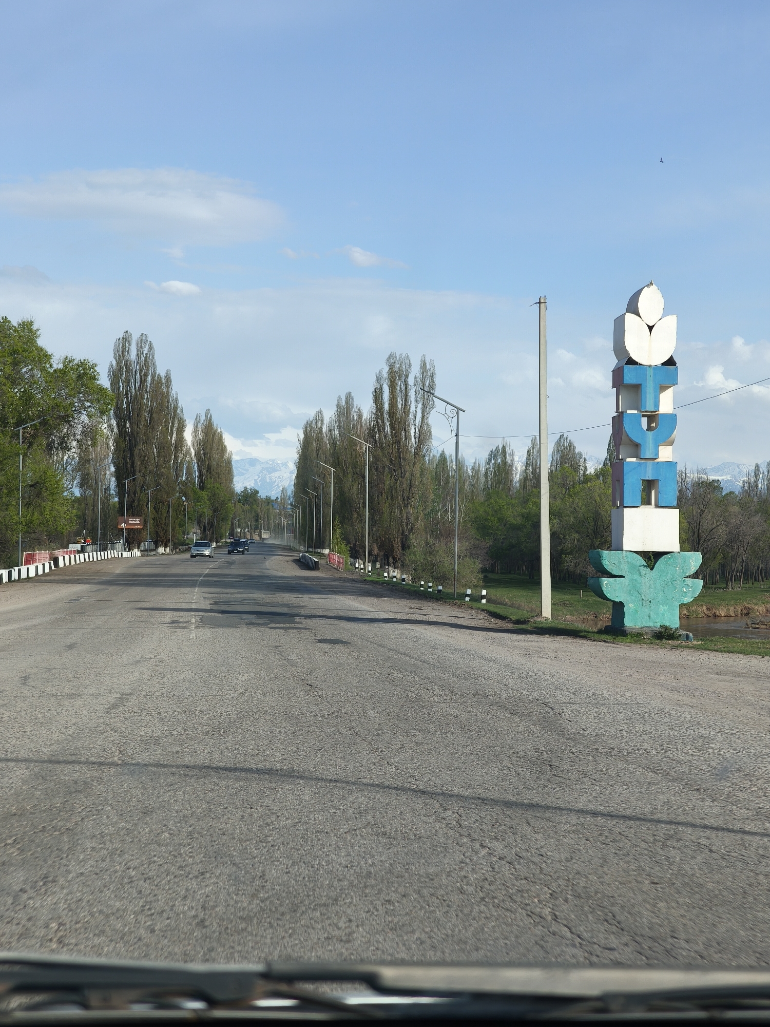 Road entrance to Birlik, Kyrgyzstan documented with welcome sign