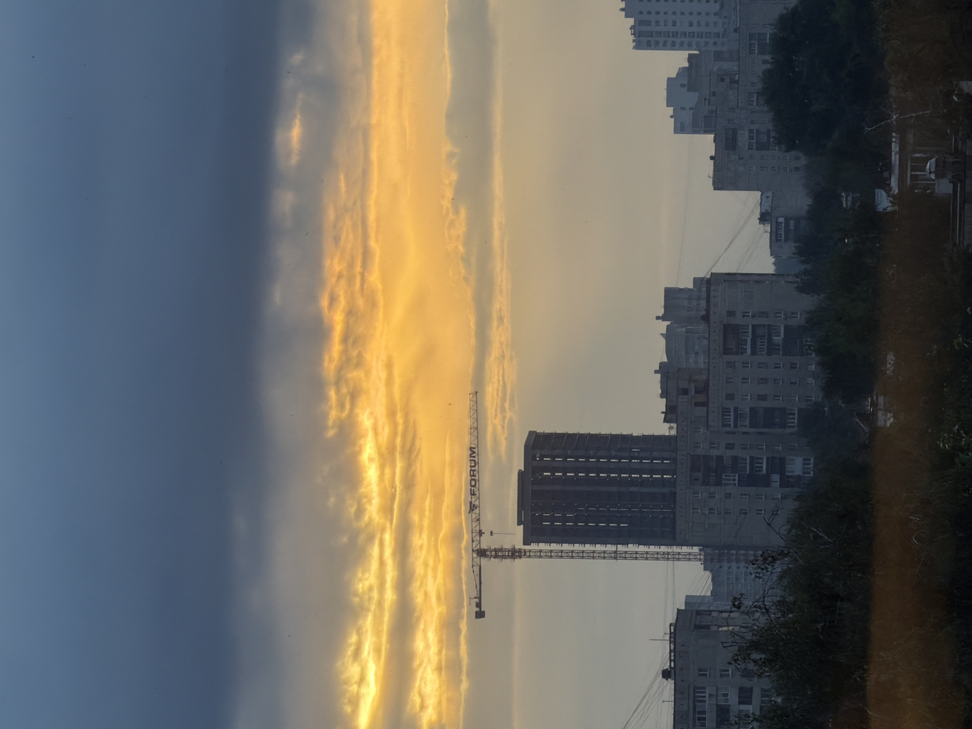 Crane and unfinished buildings under a stormy Yekaterinburg sky