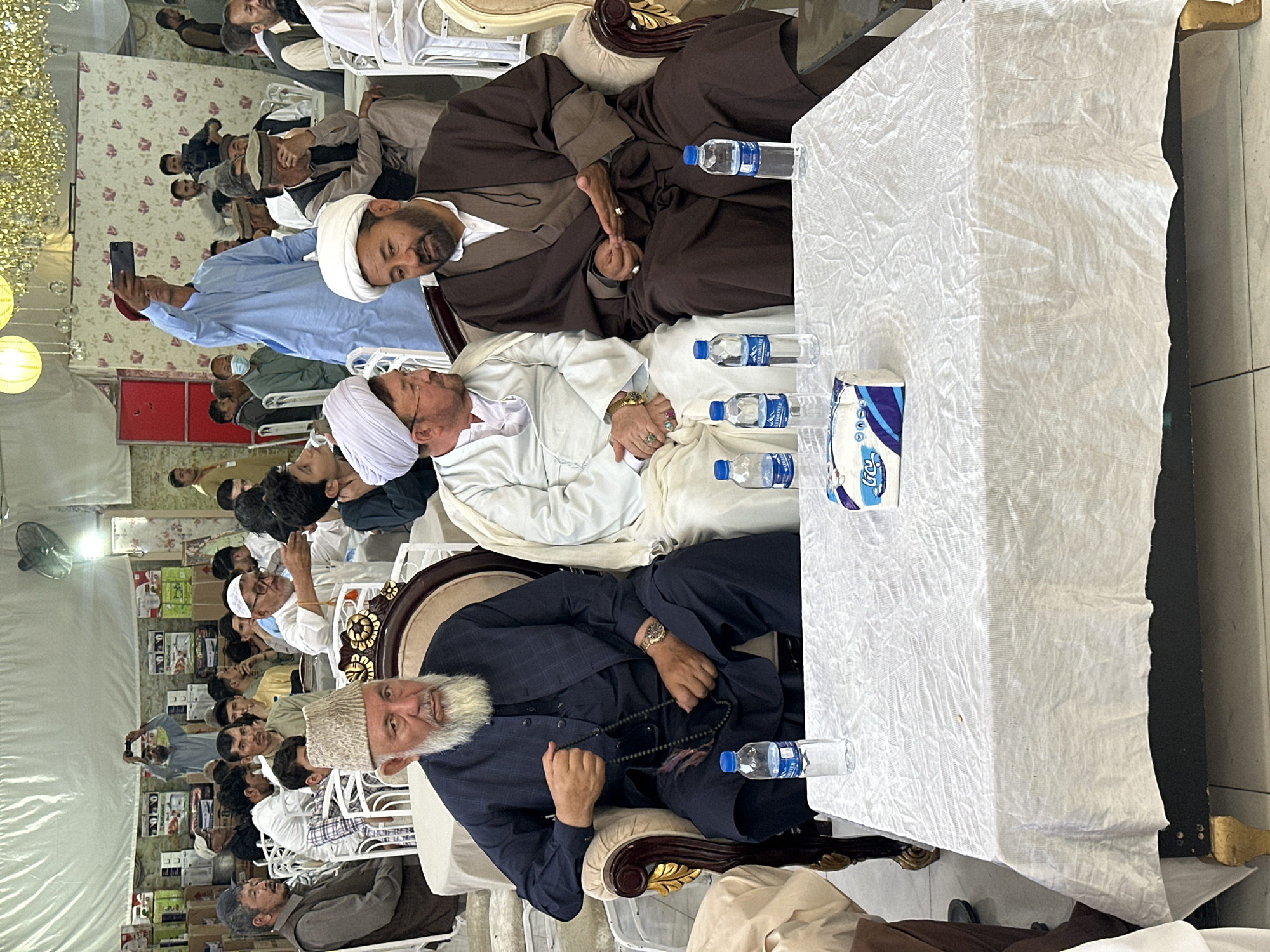 Traditional gathering of men in formal attire, Quetta