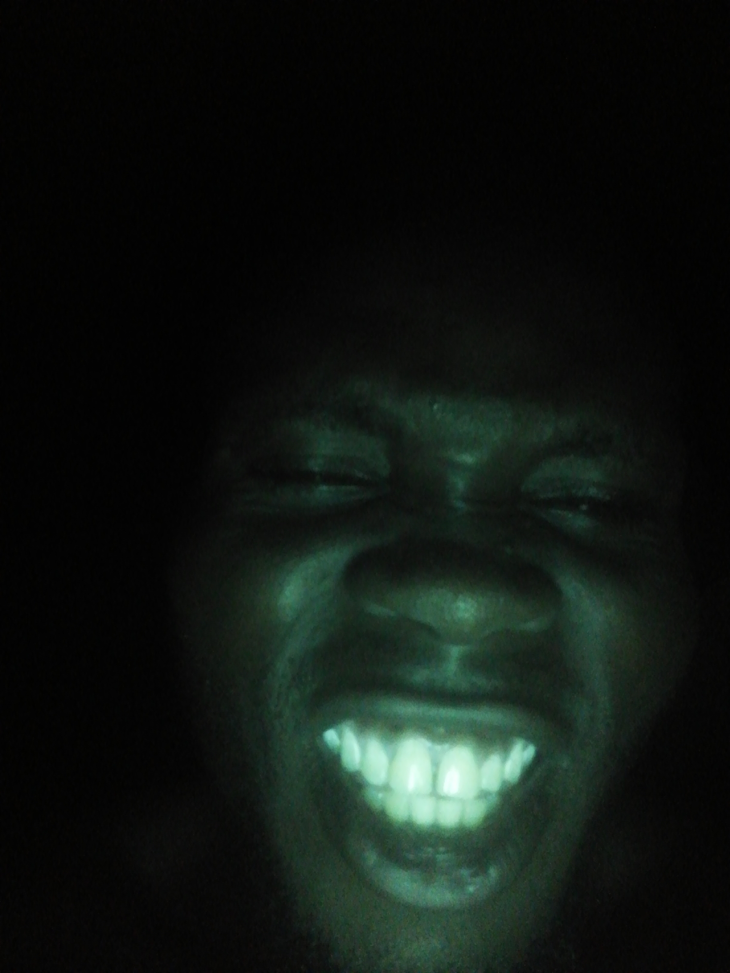 Person photographed in low-light conditions, unknown location