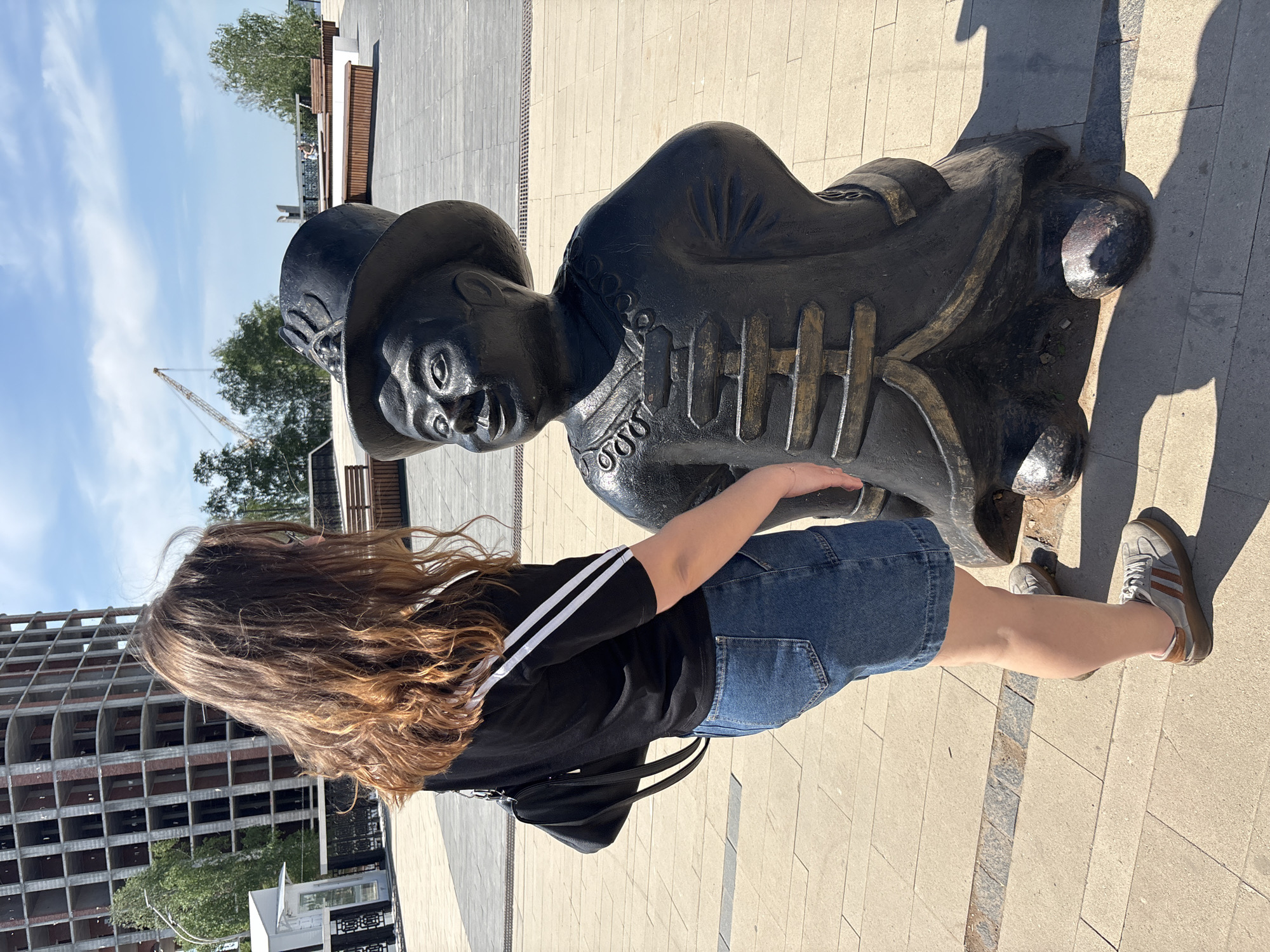 Woman photographed near statue in Izhevsk public square