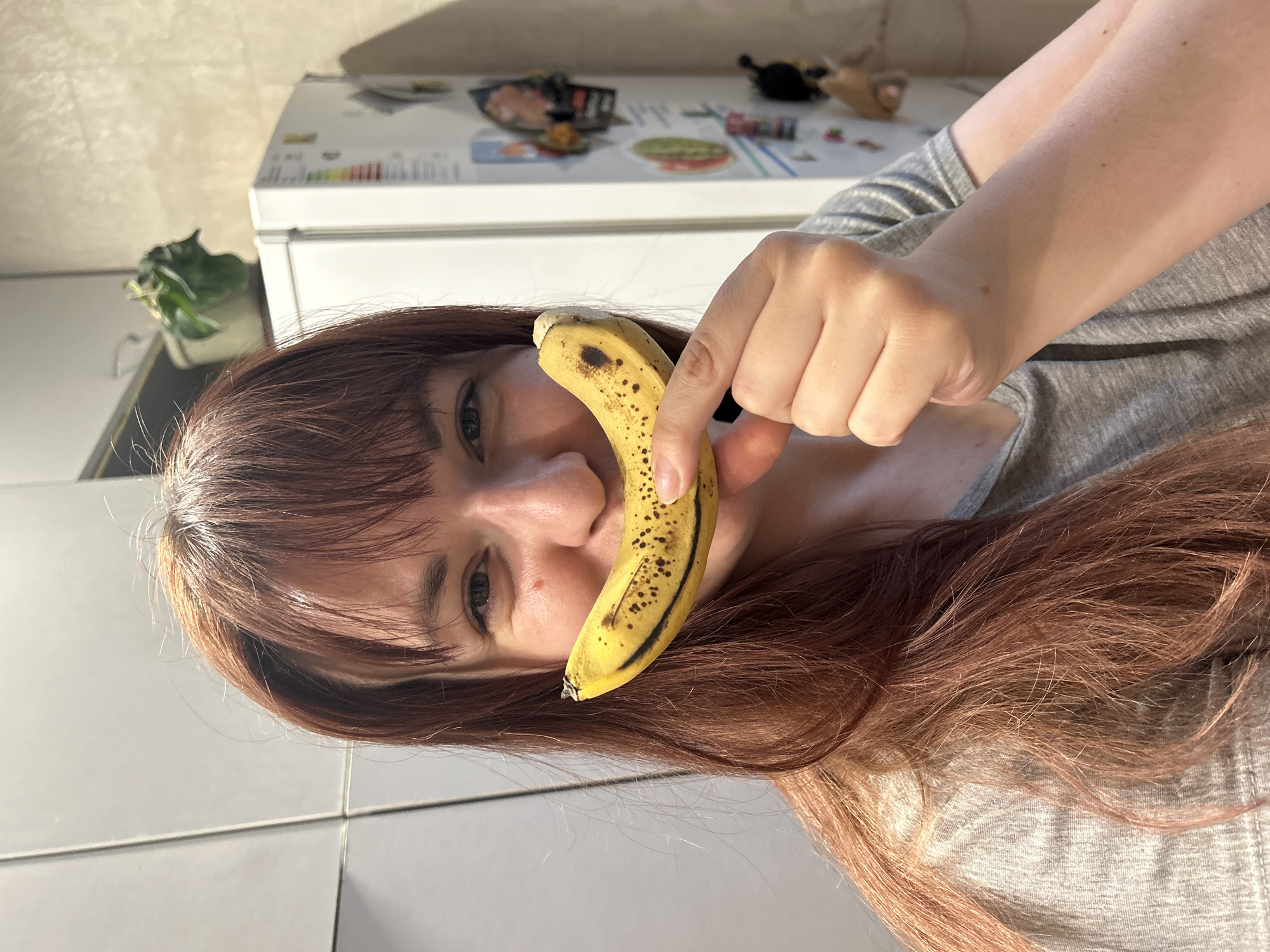 Woman poses with book and banana in Russian town