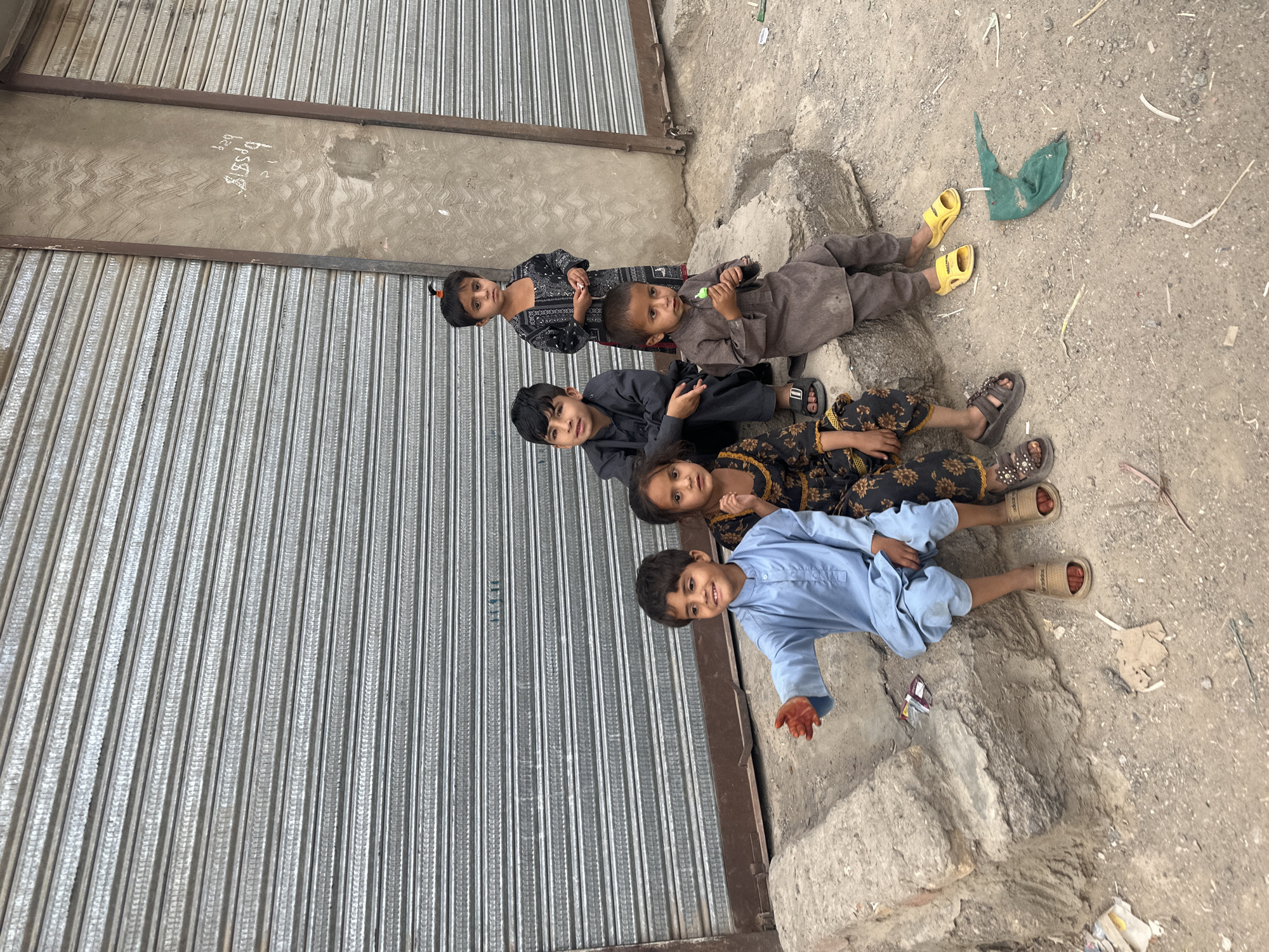 Five children lie near closed storefront in Quetta