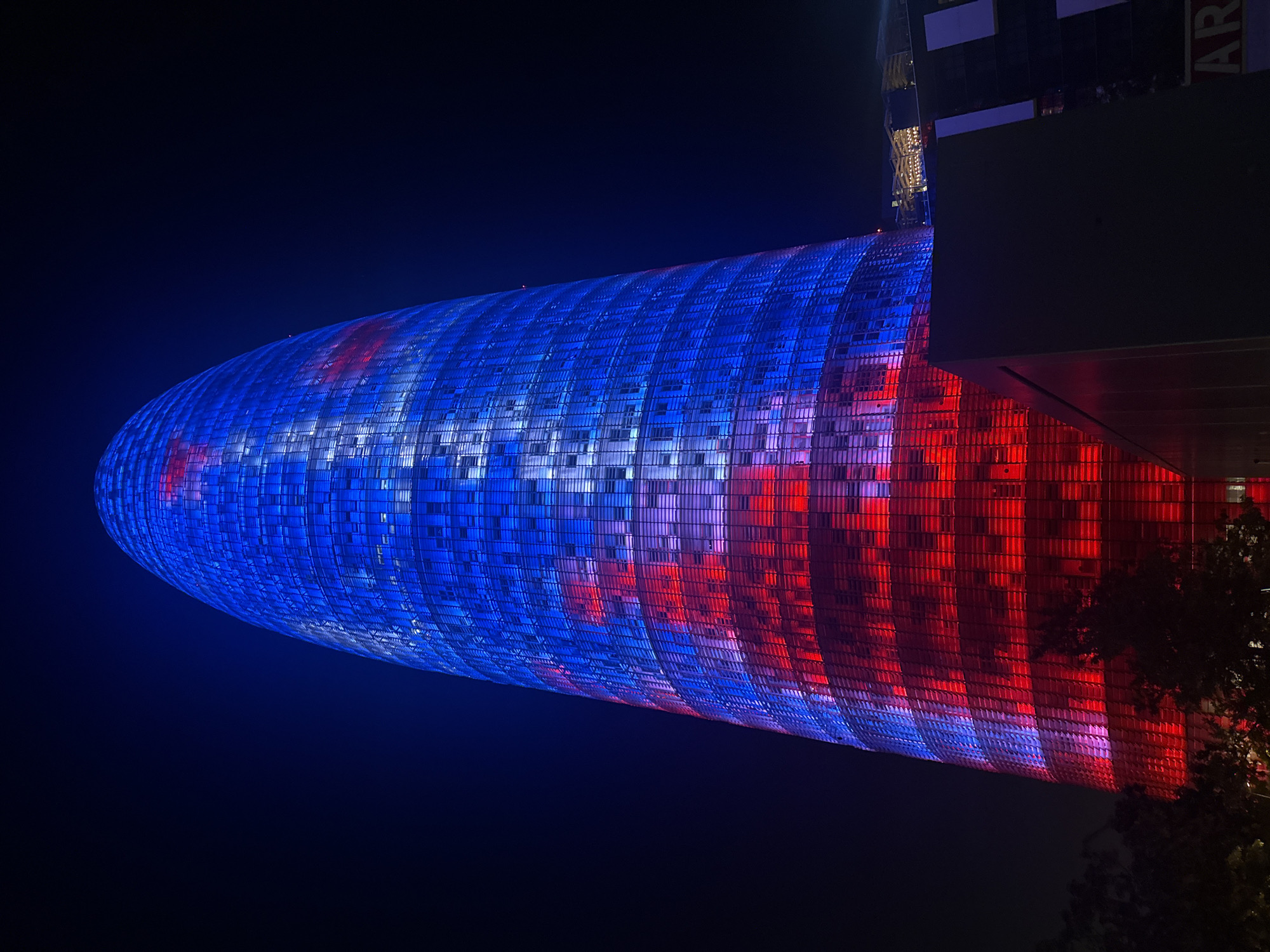 Night in Barcelona: Torre Agbar glows over a quiet park