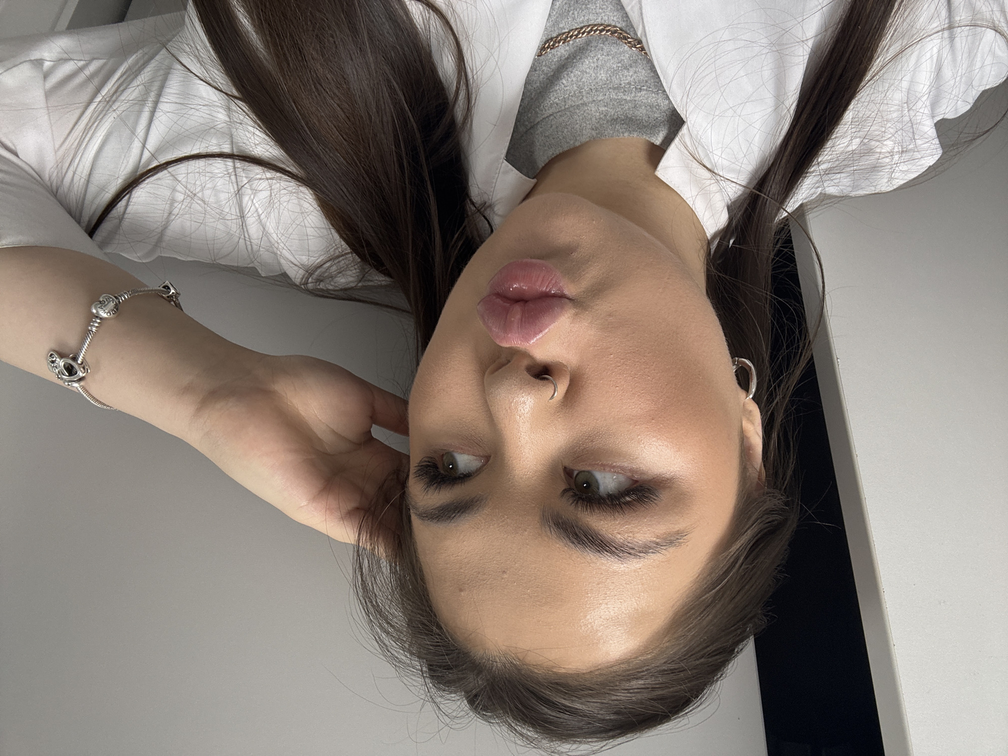 Woman applies skincare cream during morning routine in Pargolovo