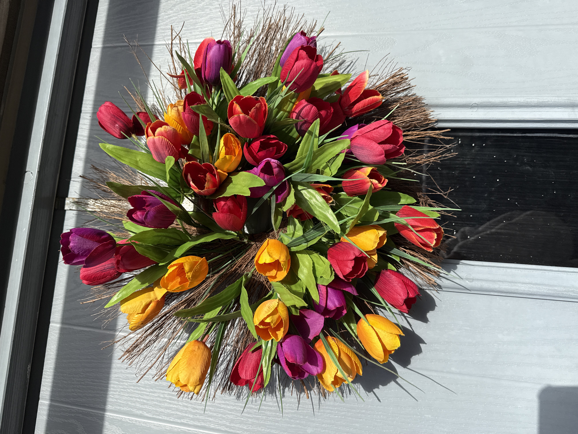 Spring tulip wreath adorns residential door in Great Yarmouth