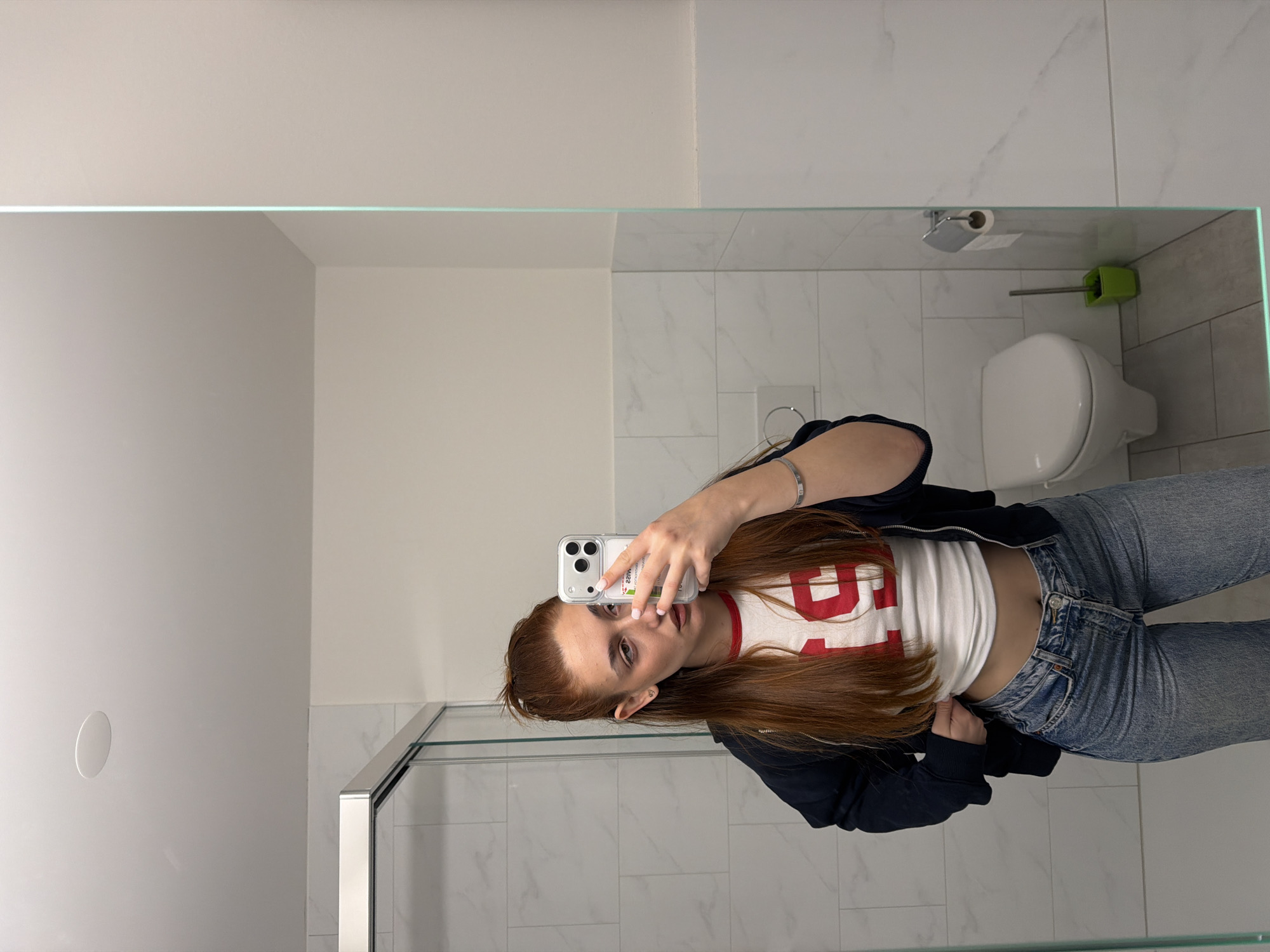 Woman takes bathroom mirror selfies in Bremgarten, Switzerland