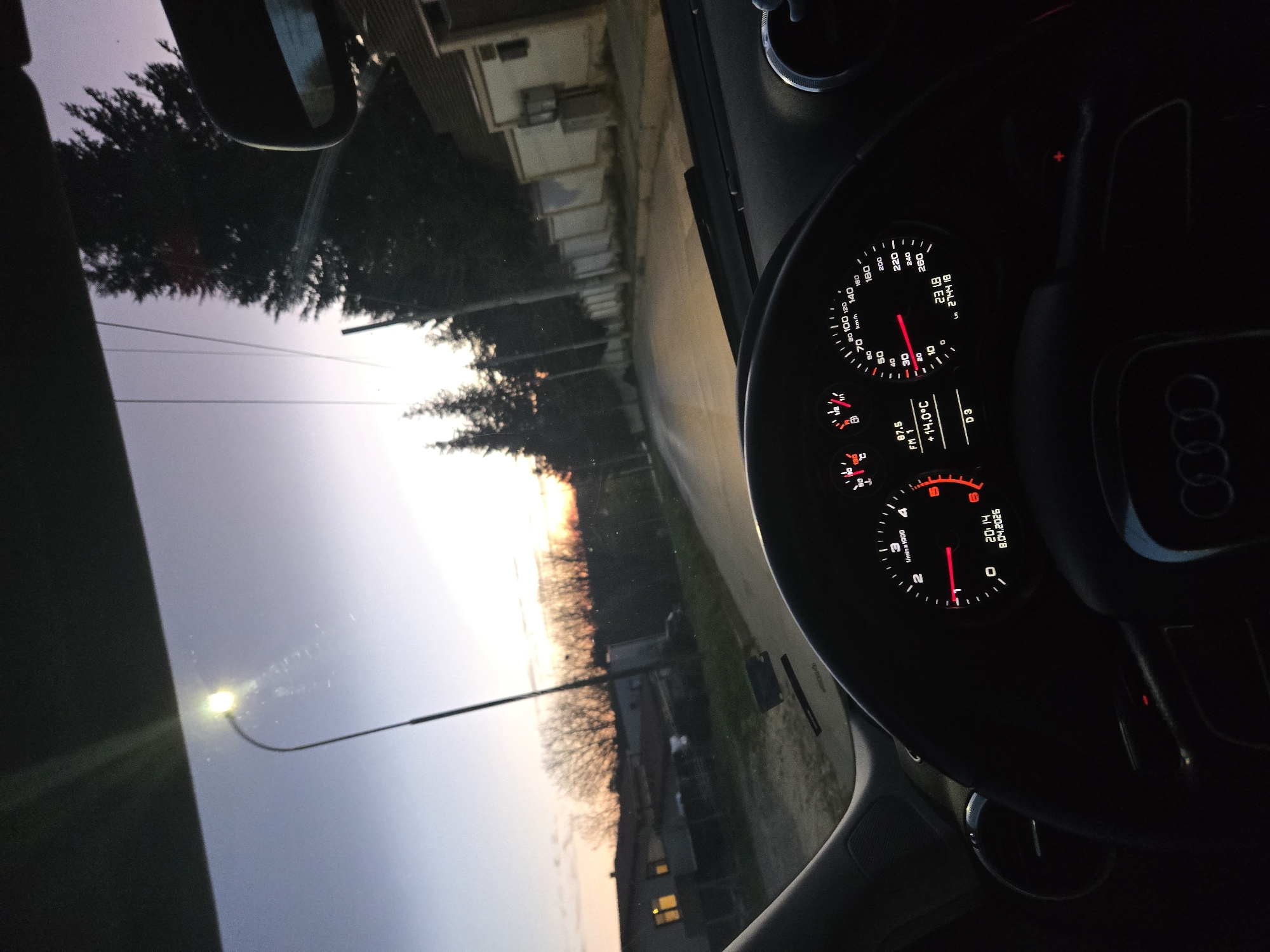 Driver pauses on road during sunset, radio playing