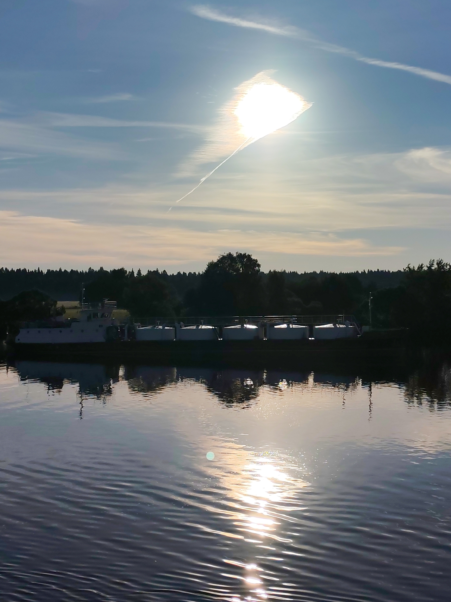 Russian cargo ships navigate river system during dawn hours