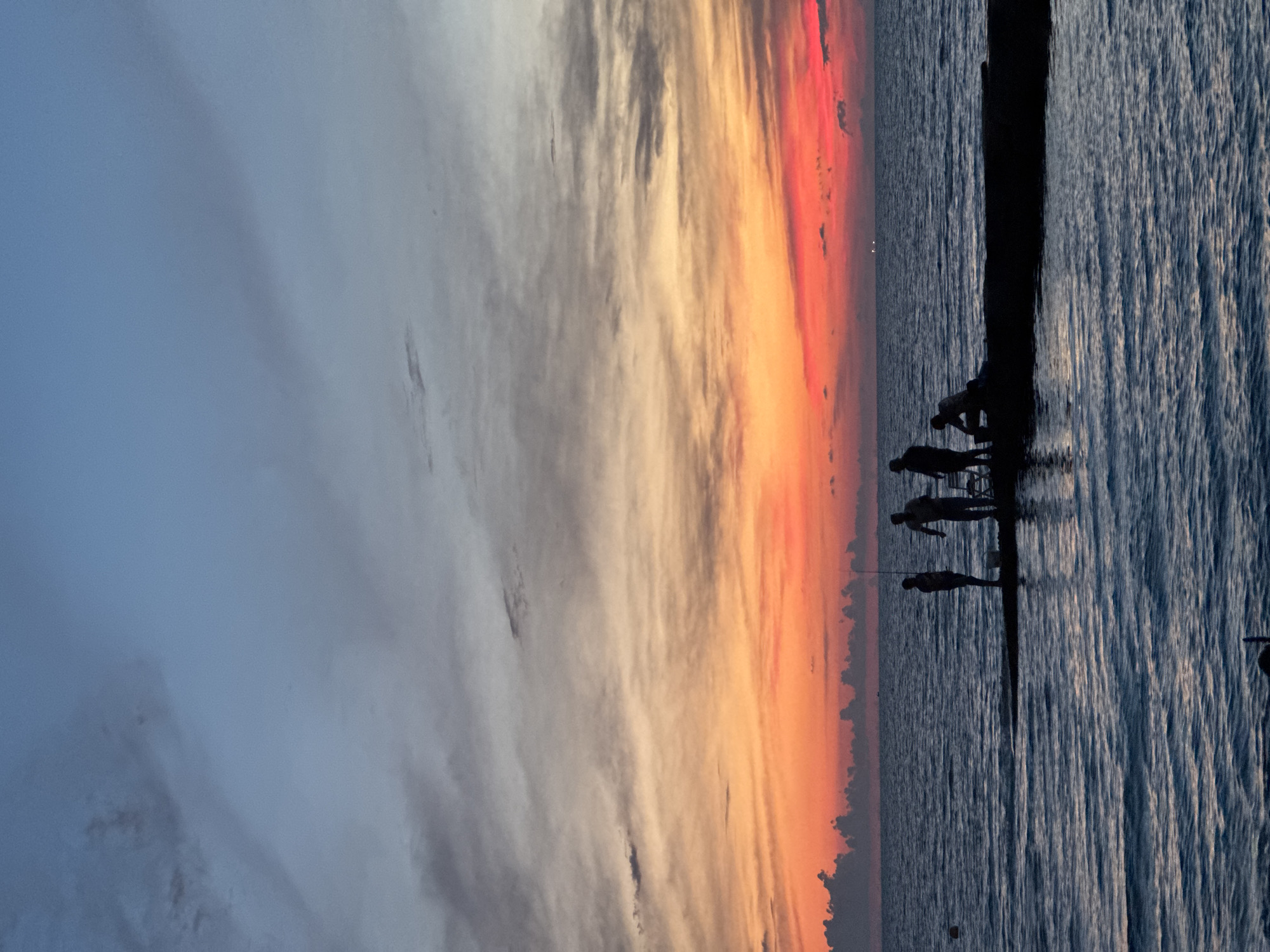 Evening waterfront gathering in Sochi with music, vendors, and sunset views