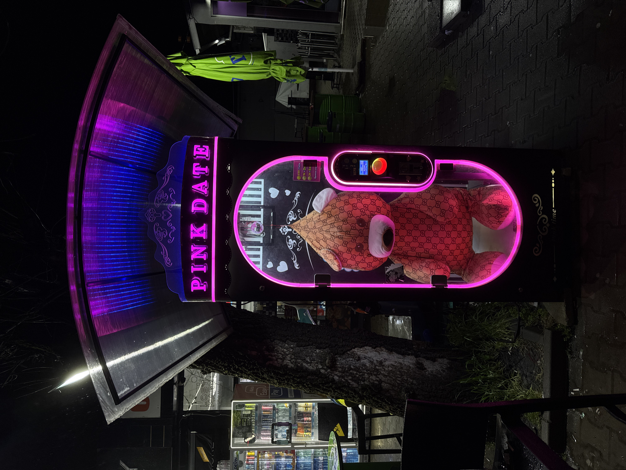 Neon-lit storefronts illuminate Sofia streets during late night hours