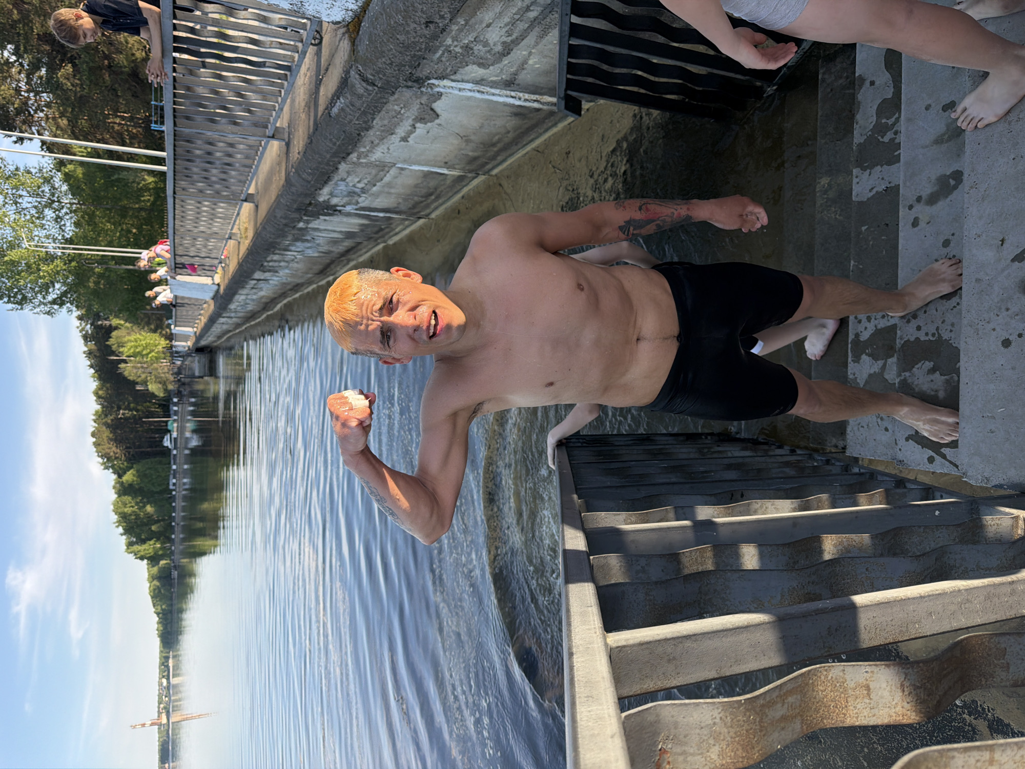 Man holds white object while swimming in Chaikovsky, Russia
