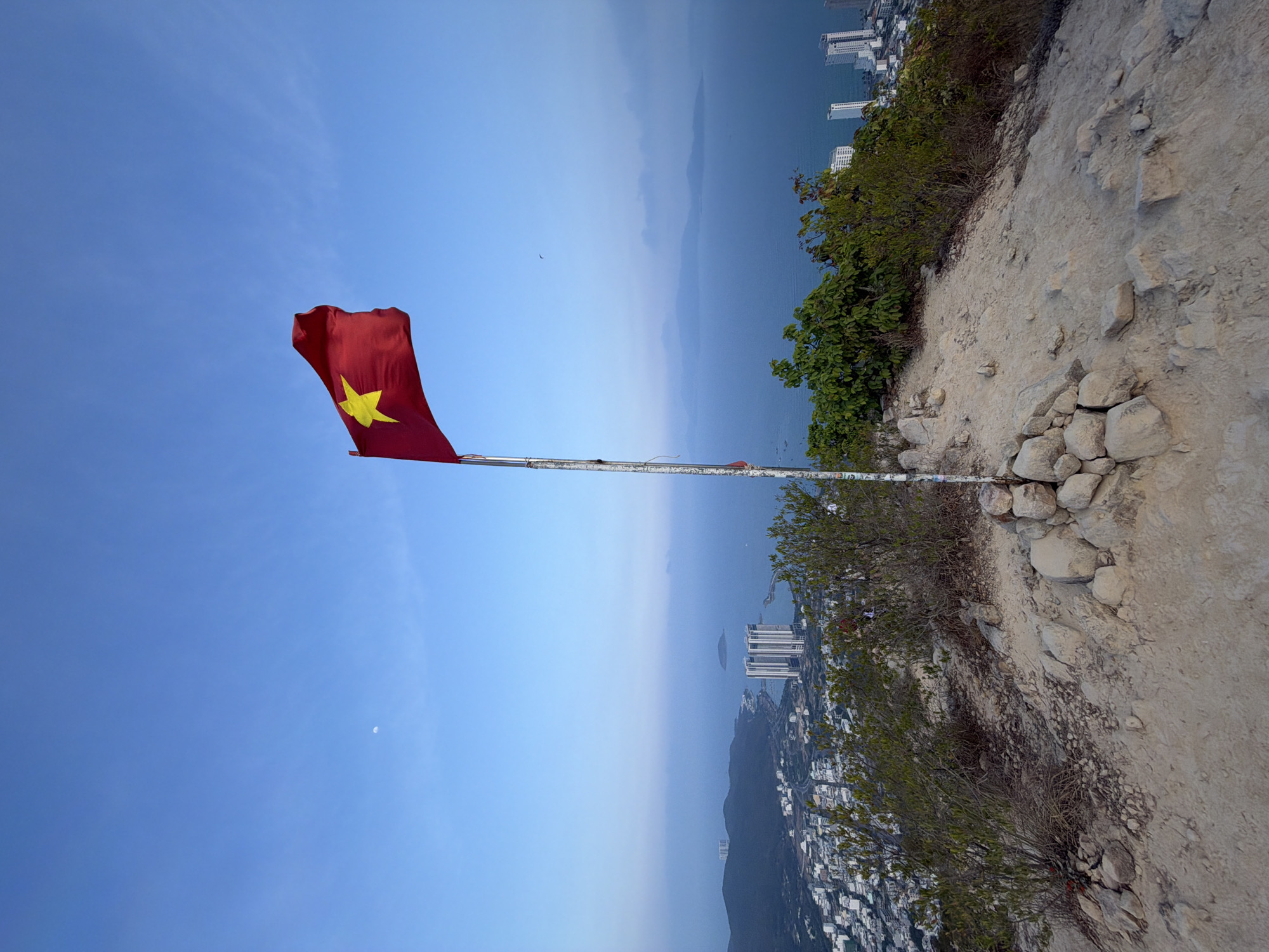 Vietnamese flag flies on rugged terrain near Nha Trang