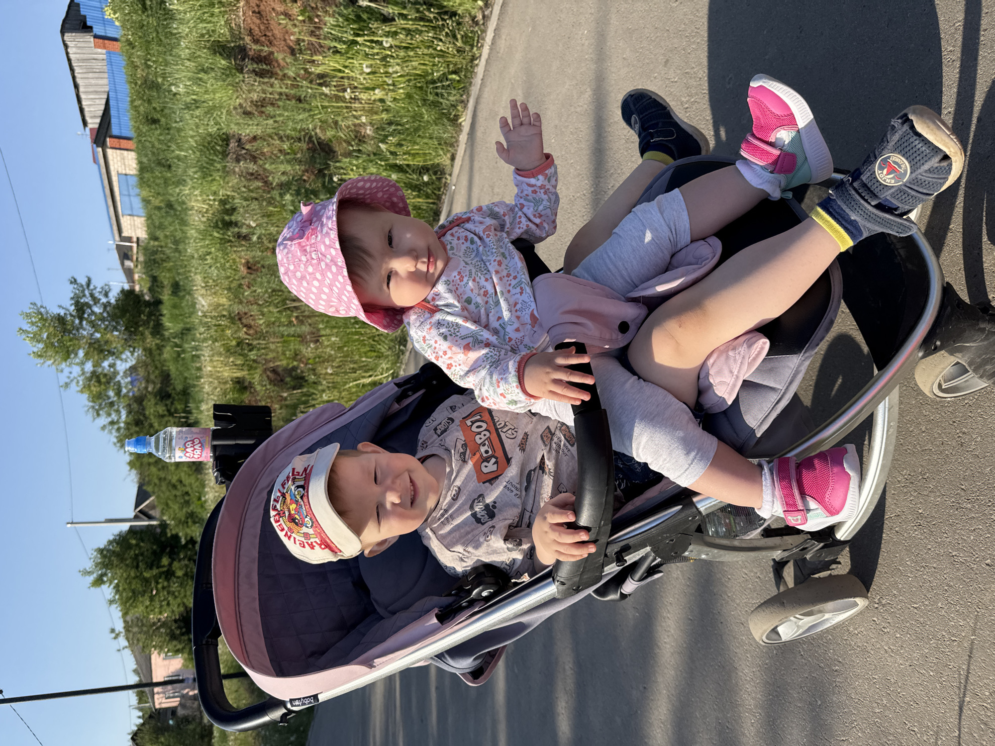 Two children share stroller ride in Zav'yalovo, Russia