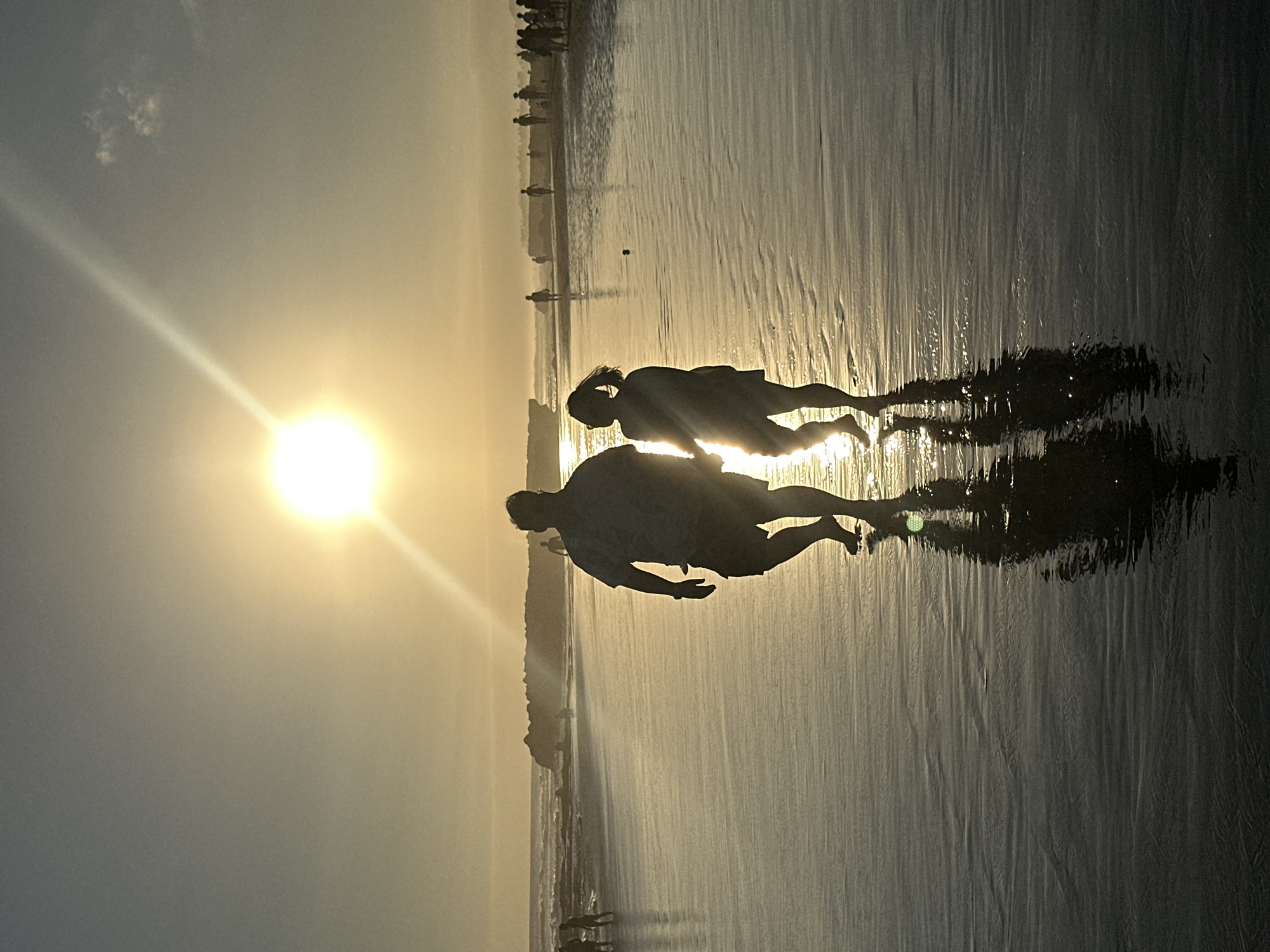Sunset stroll on the wet sand, North Kuta beach.